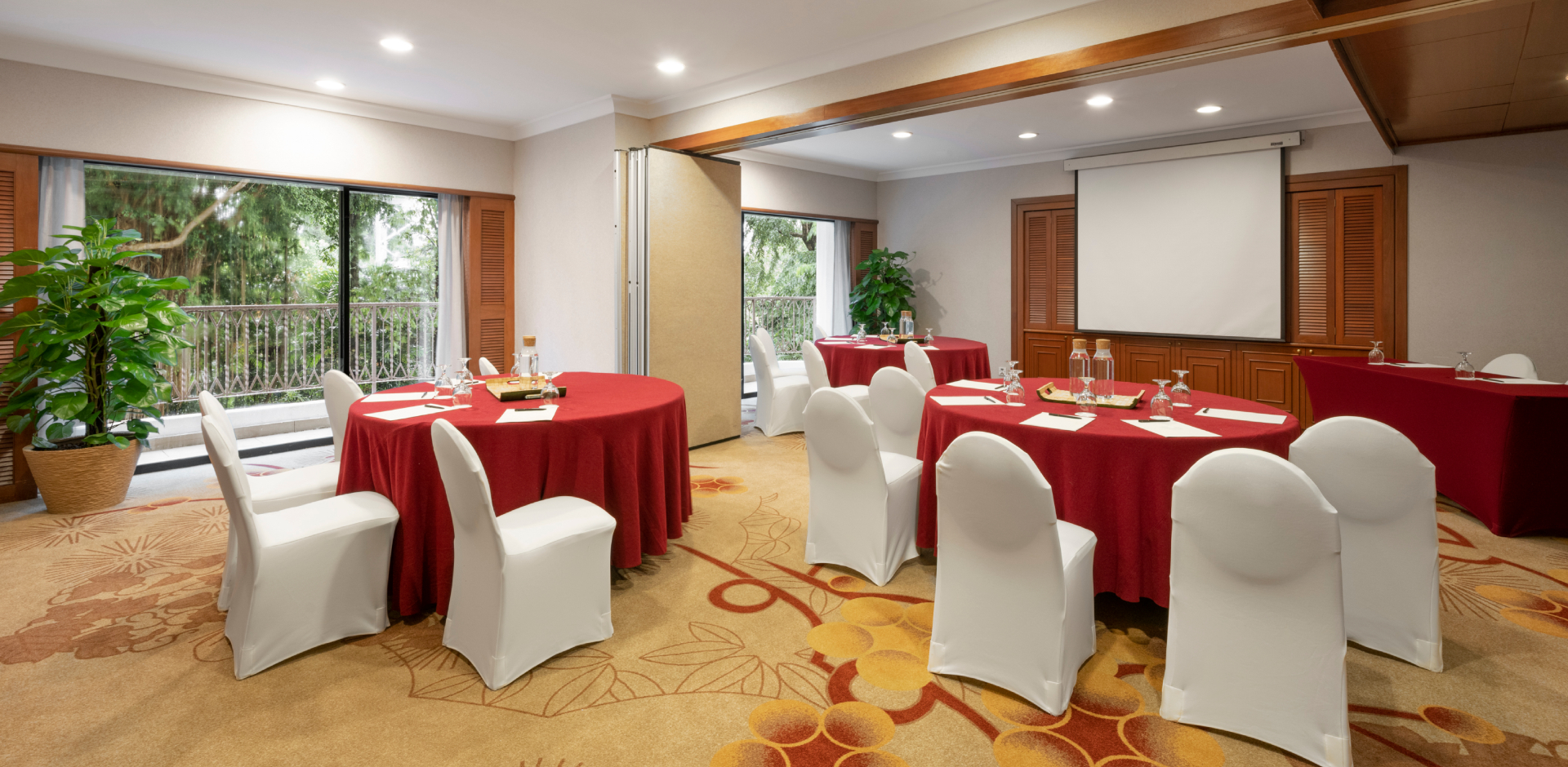 Function room in Shangri-La Singapore, bright with round tables for meetings and conferences.