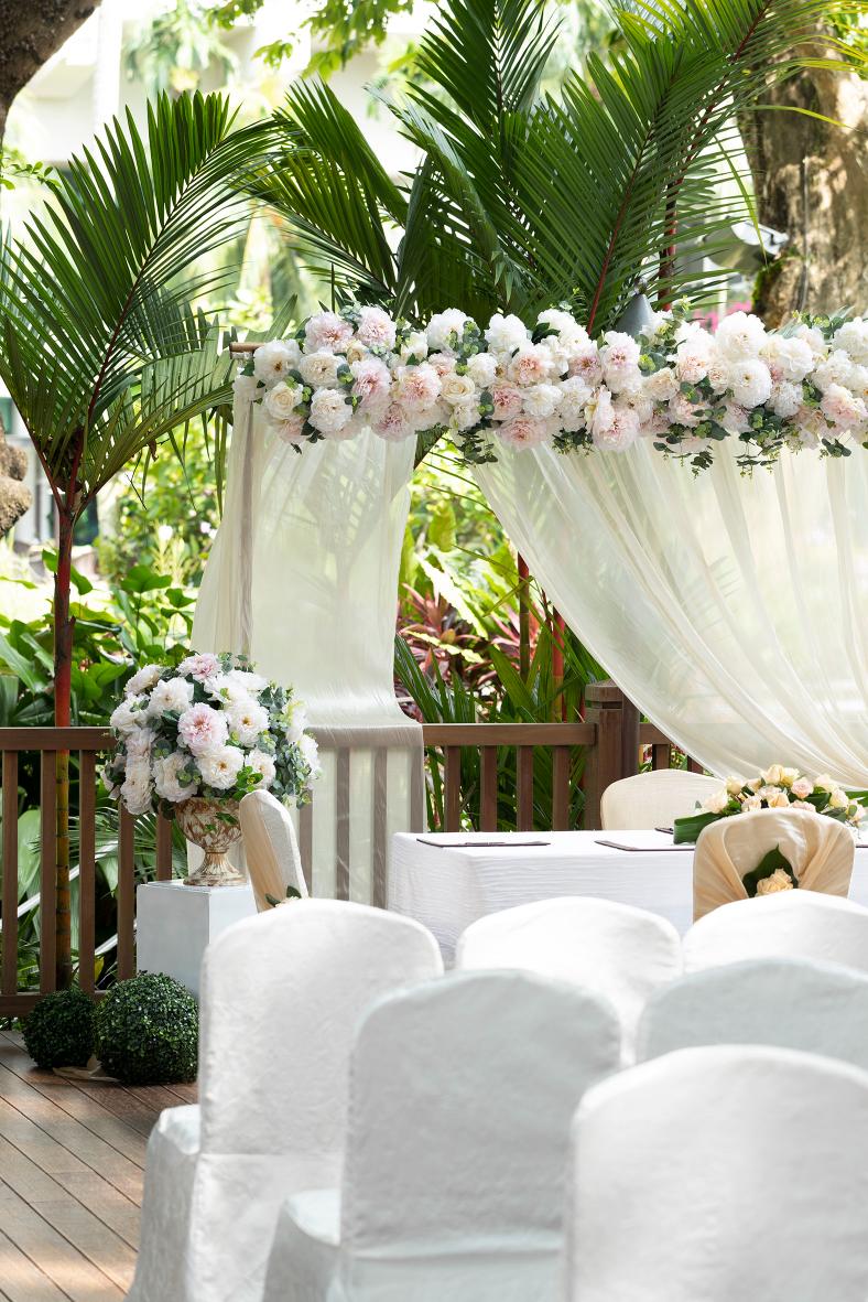Banyan Deck at Shangri-La Singapore, elegant outdoor wedding venue with floral archway.