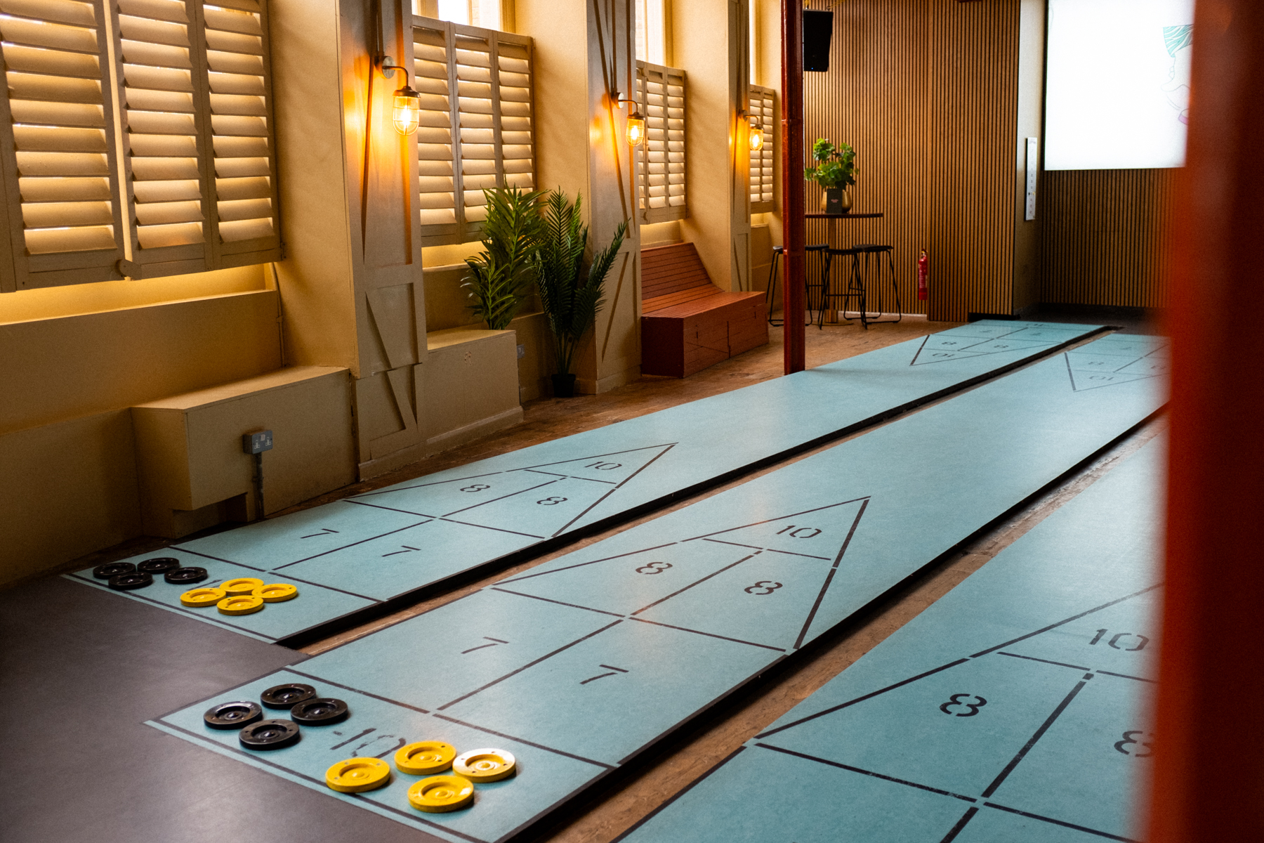 Exclusive First Floor Hire at Shuffle Club with shuffleboard courts for team-building events.