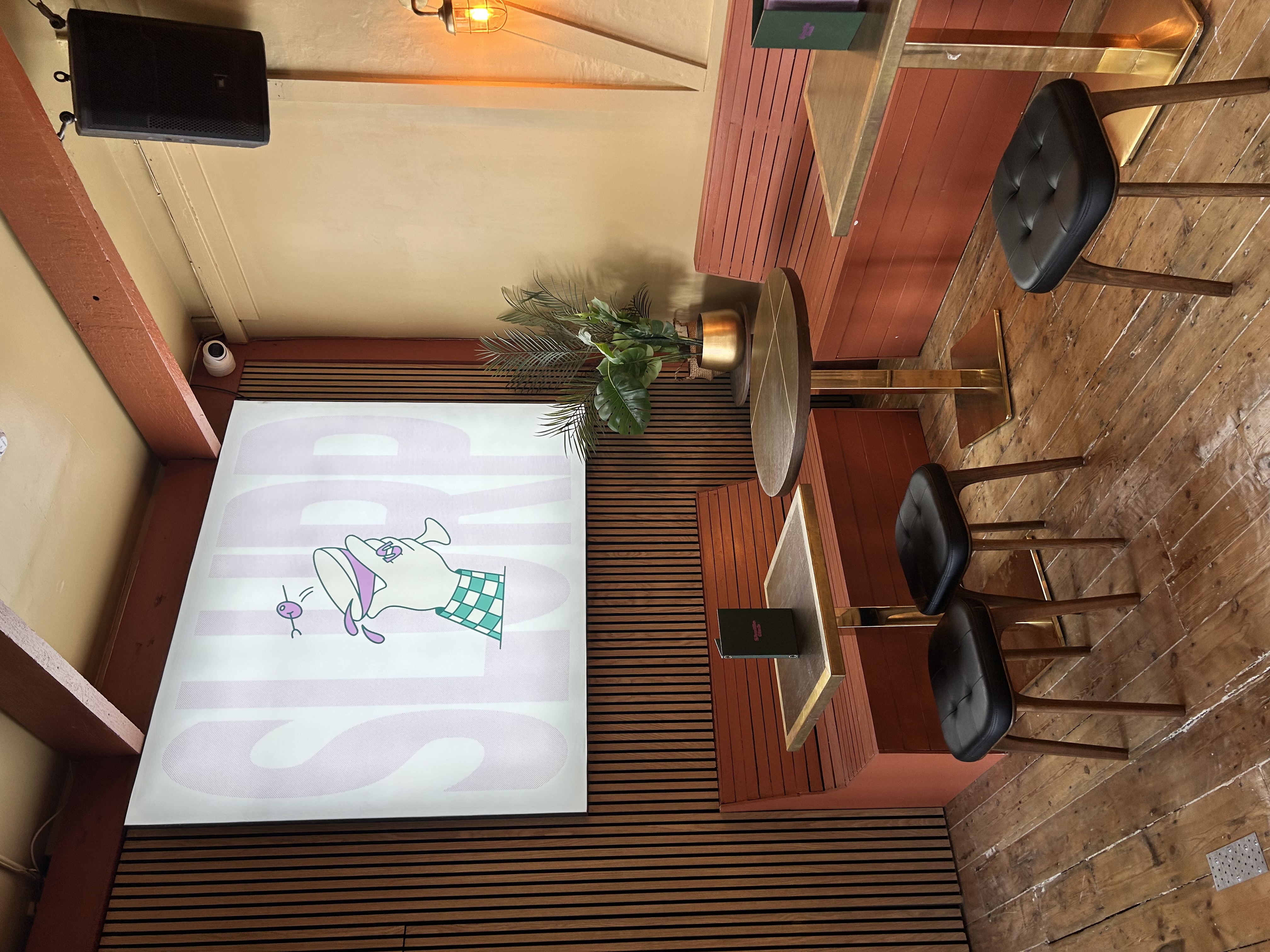 Cozy meeting space with booth seating in Shuffle Club for casual events.