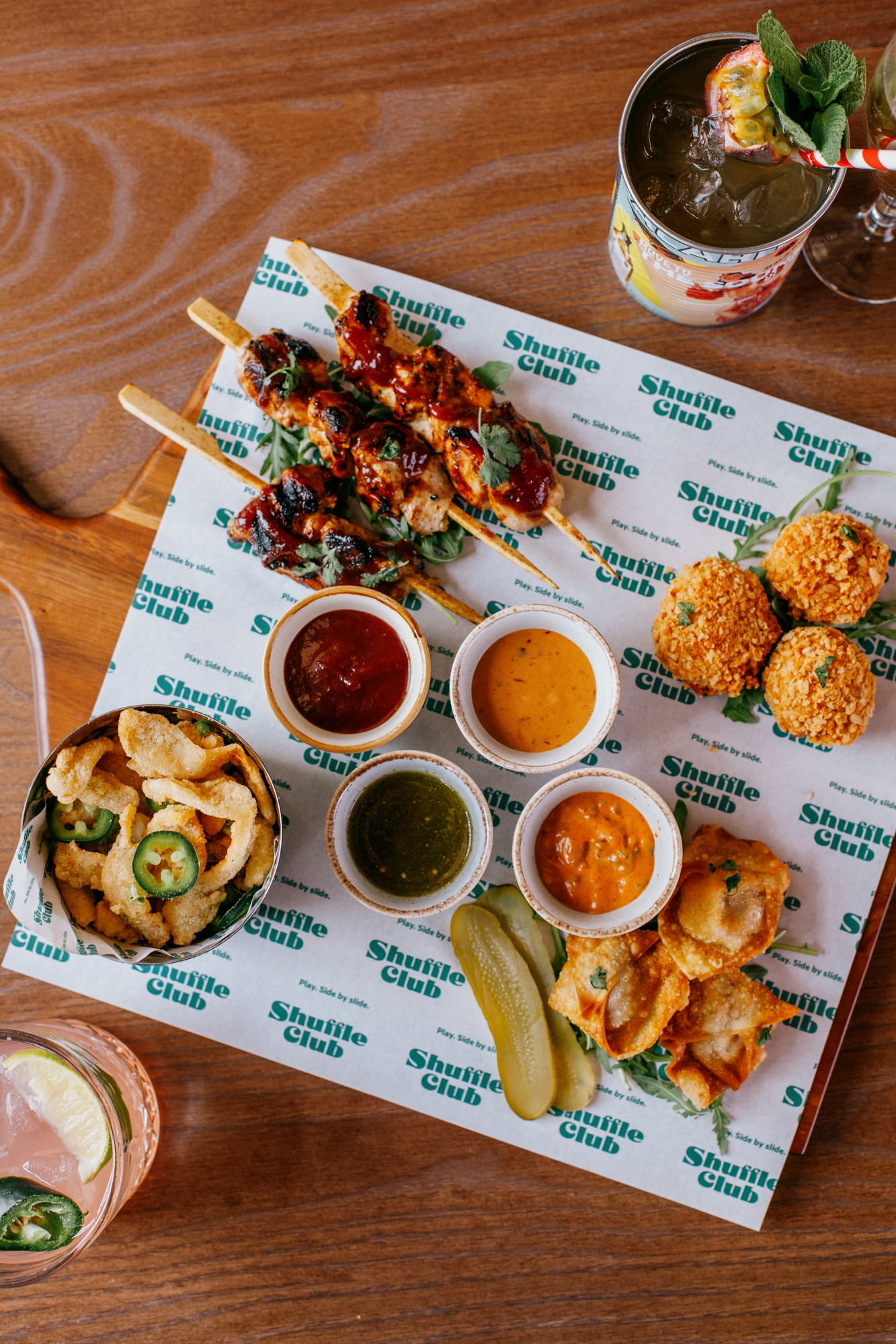 Vibrant appetizers on branded paper for a casual networking event at Shuffle Club.