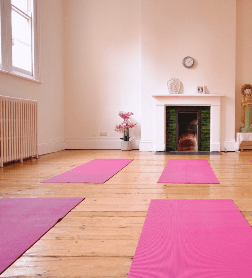 Serene yoga studio with pink mats at Jamyang Buddhist Centre for wellness retreats.