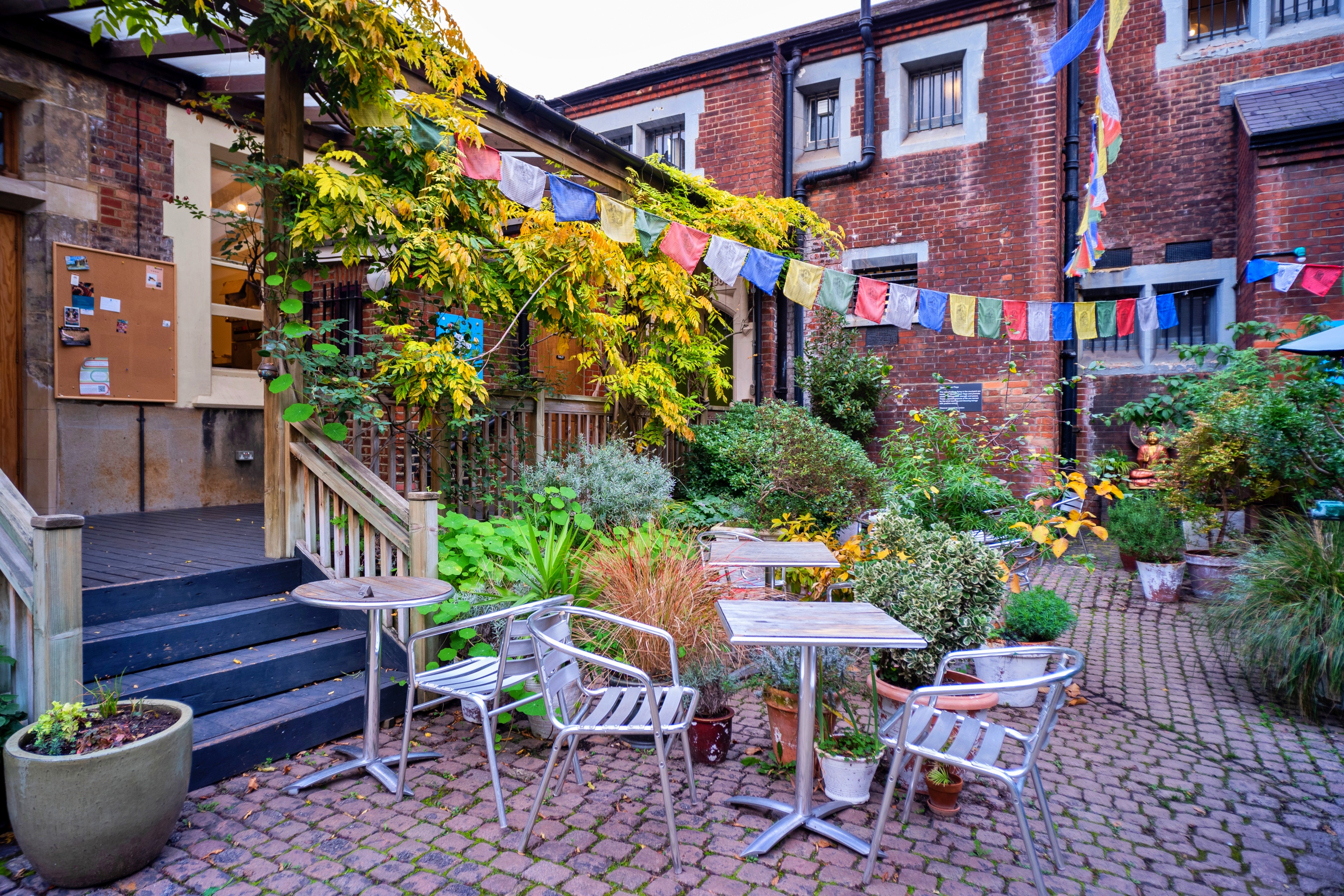 Charming outdoor cafe at Jamyang Buddhist Centre, ideal for casual meetings and networking.