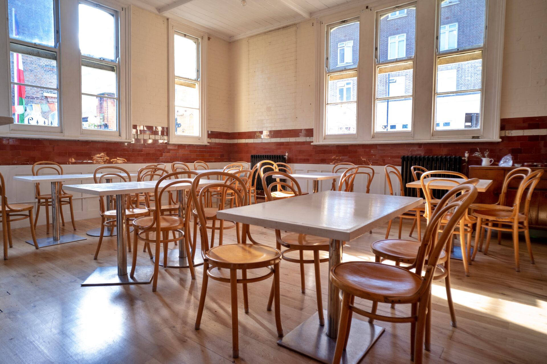 Versatile event space with natural light at Jamyang Buddhist Centre, ideal for receptions and meetings.