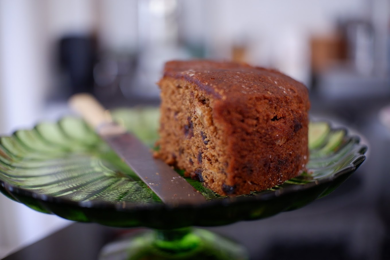 Elegant cake slice on green glass at Jamyang Buddhist Centre cafe for events.