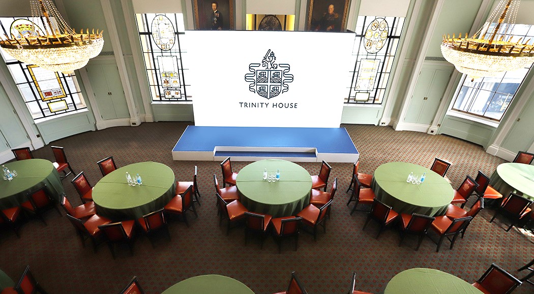 Elegant event space at Trinity House with round tables, ideal for conferences and gatherings.