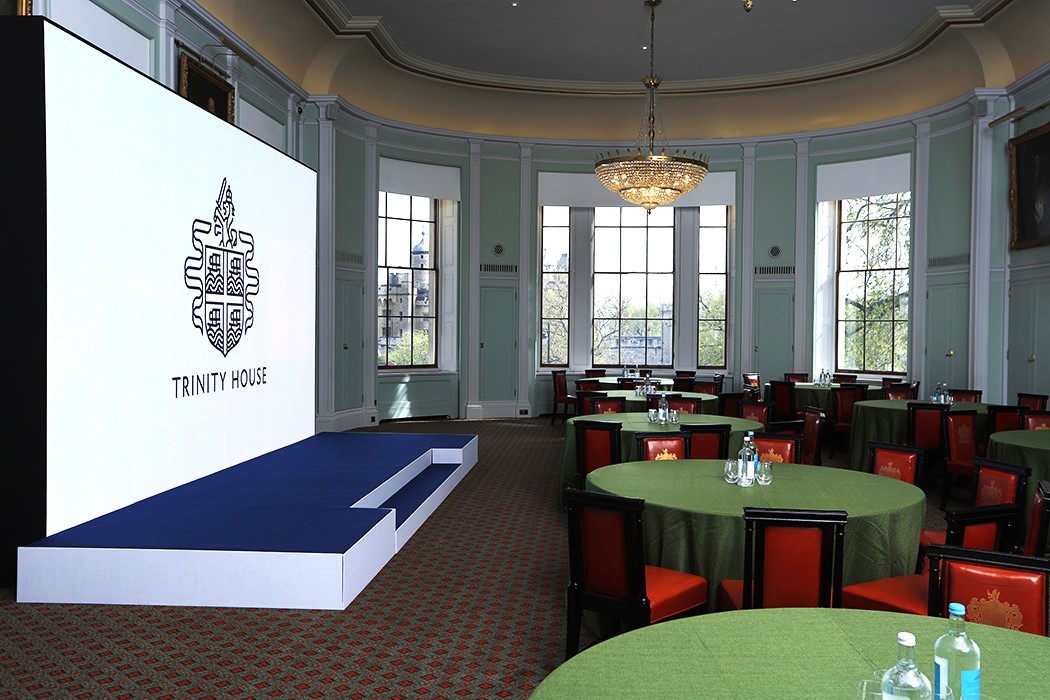 Elegant event space at Trinity House with large screen, ideal for conferences and gatherings.