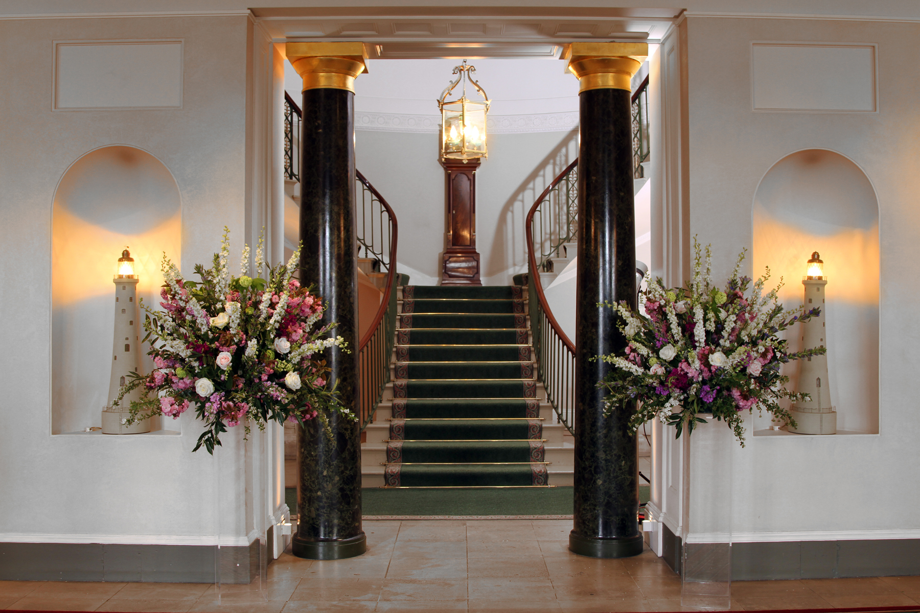 Elegant entrance with grand staircases at Trinity House for upscale events.