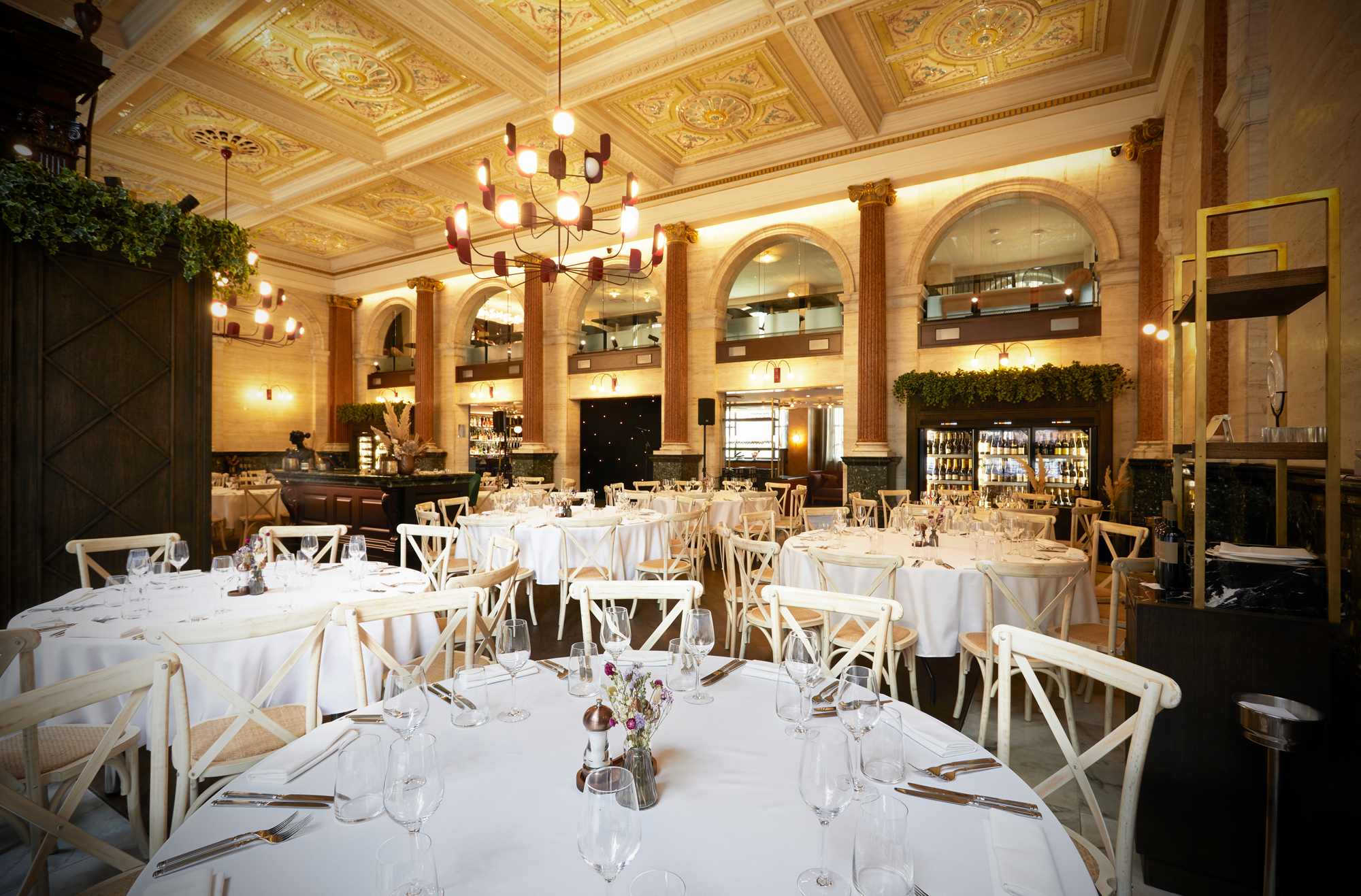 Elegant event space in Piazza Italiana with round tables for upscale gatherings.