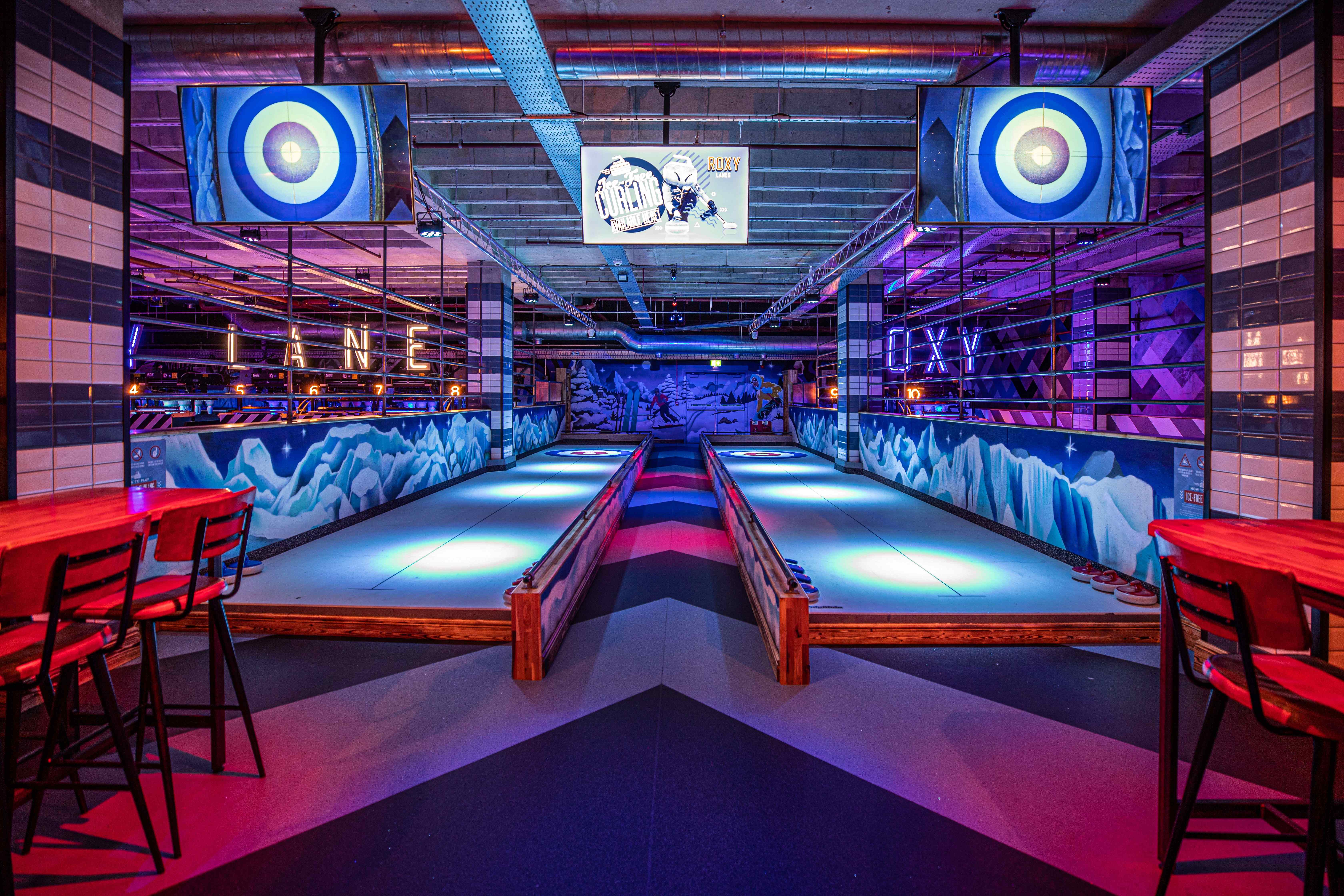 Vibrant event space at Roxy Lanes Leeds with illuminated bowling lanes for corporate gatherings.