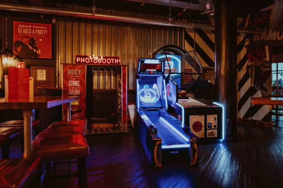 Vibrant Roxy Ball Room event space with arcade and photobooth for networking fun.