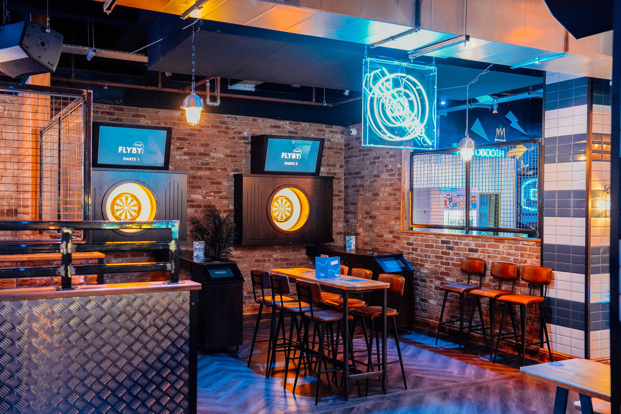 Industrial-chic Star Pins venue in Liverpool with gaming stations for team-building and networking.