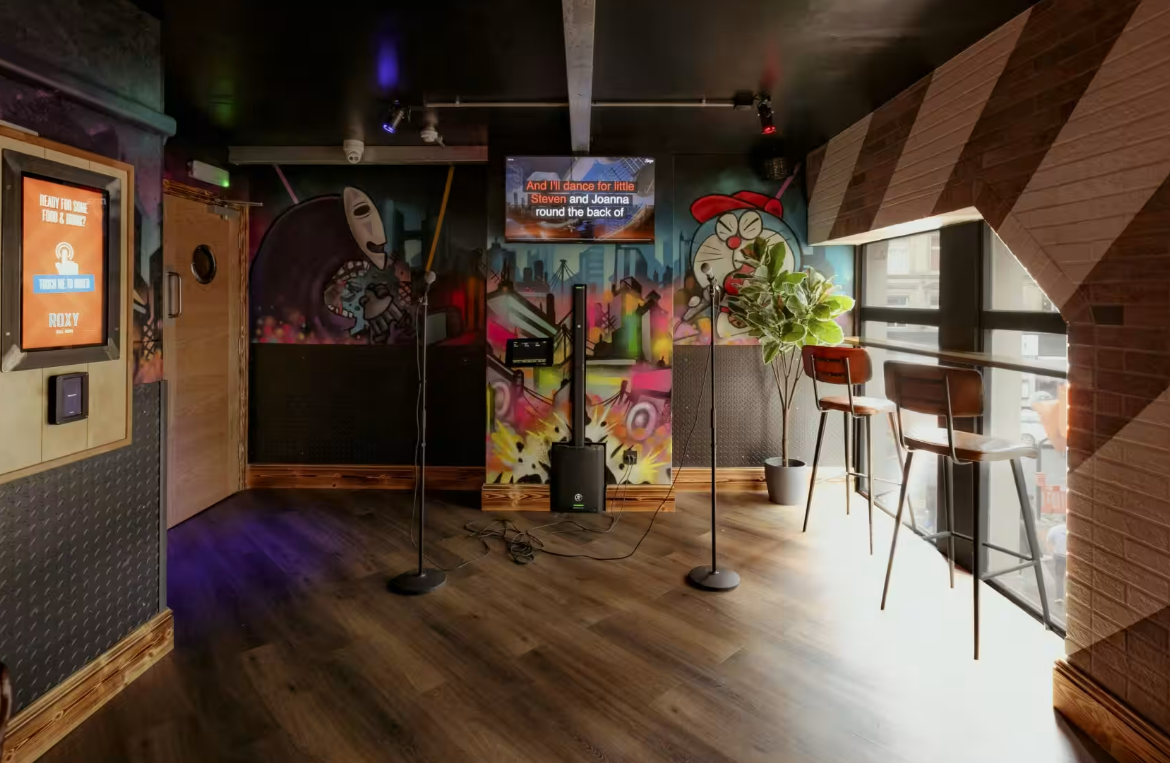 Karaoke room at Roxy Ball Room with colorful decor, perfect for team-building events.