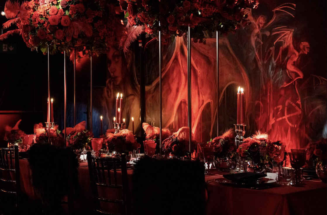 Masha Hari Theatre gala setup with lush florals and candles for a sophisticated dinner party.