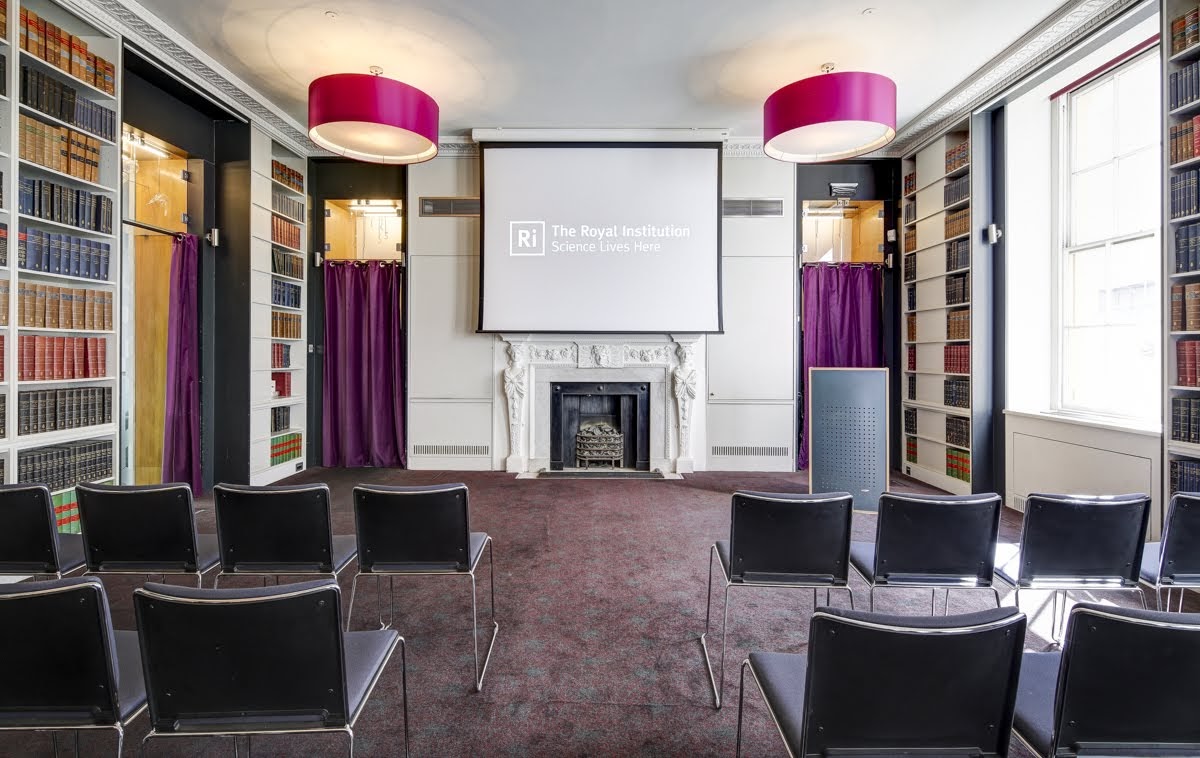 Elegant meeting room with central screen, ideal for corporate events and presentations.