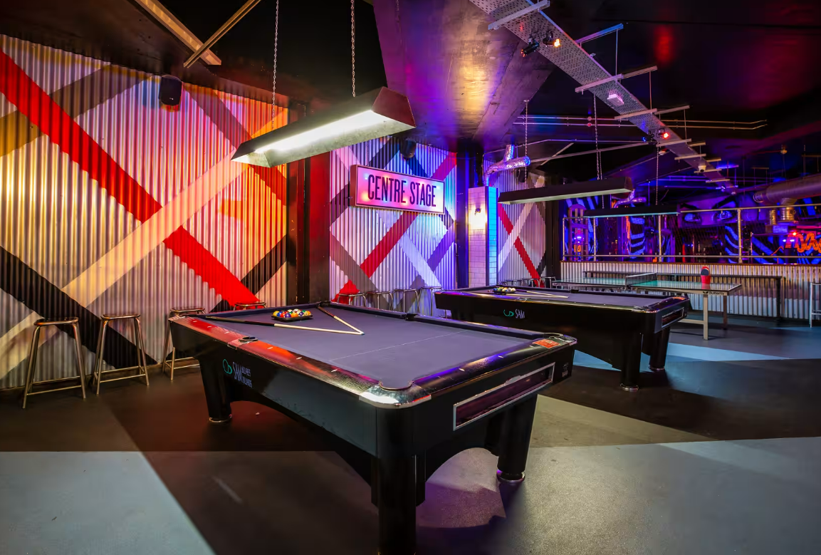 Vibrant Roxy Ball Room event space with pool tables, ideal for team-building and social gatherings.