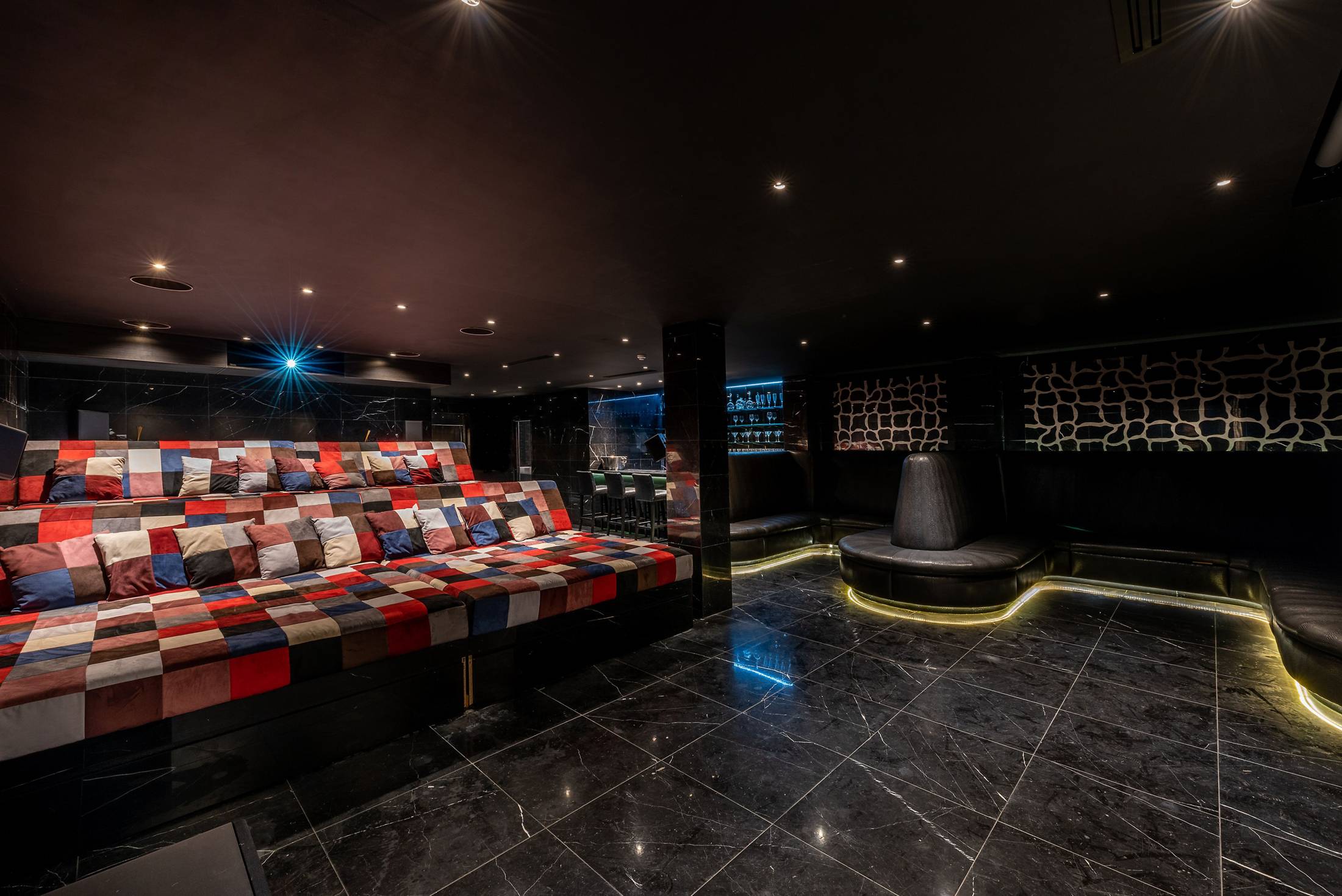 VIP cinema screening room with tiered seating for exclusive private events and corporate briefings.