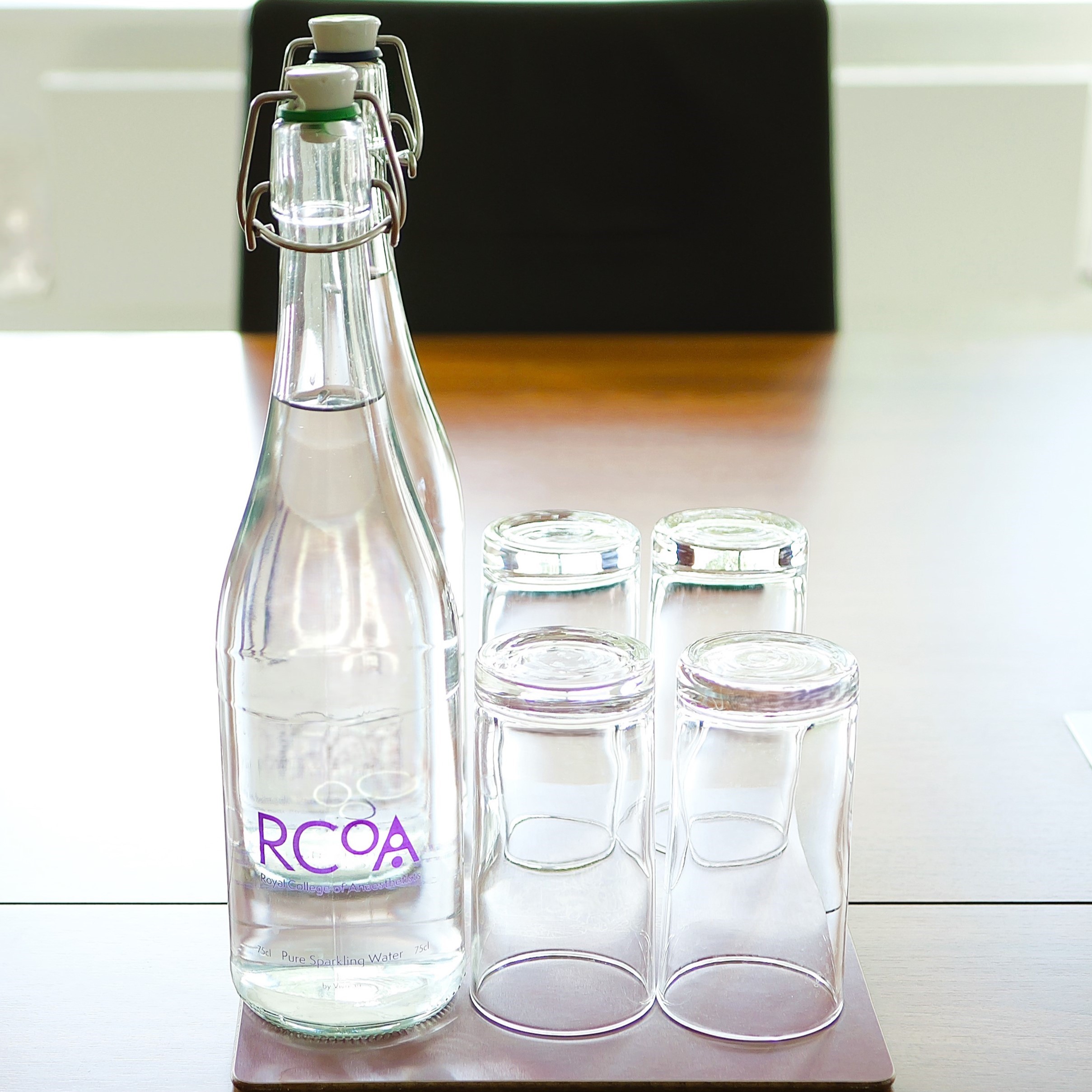 Polished Meeting Room 8 with glass water bottle, ideal for professional conferences.