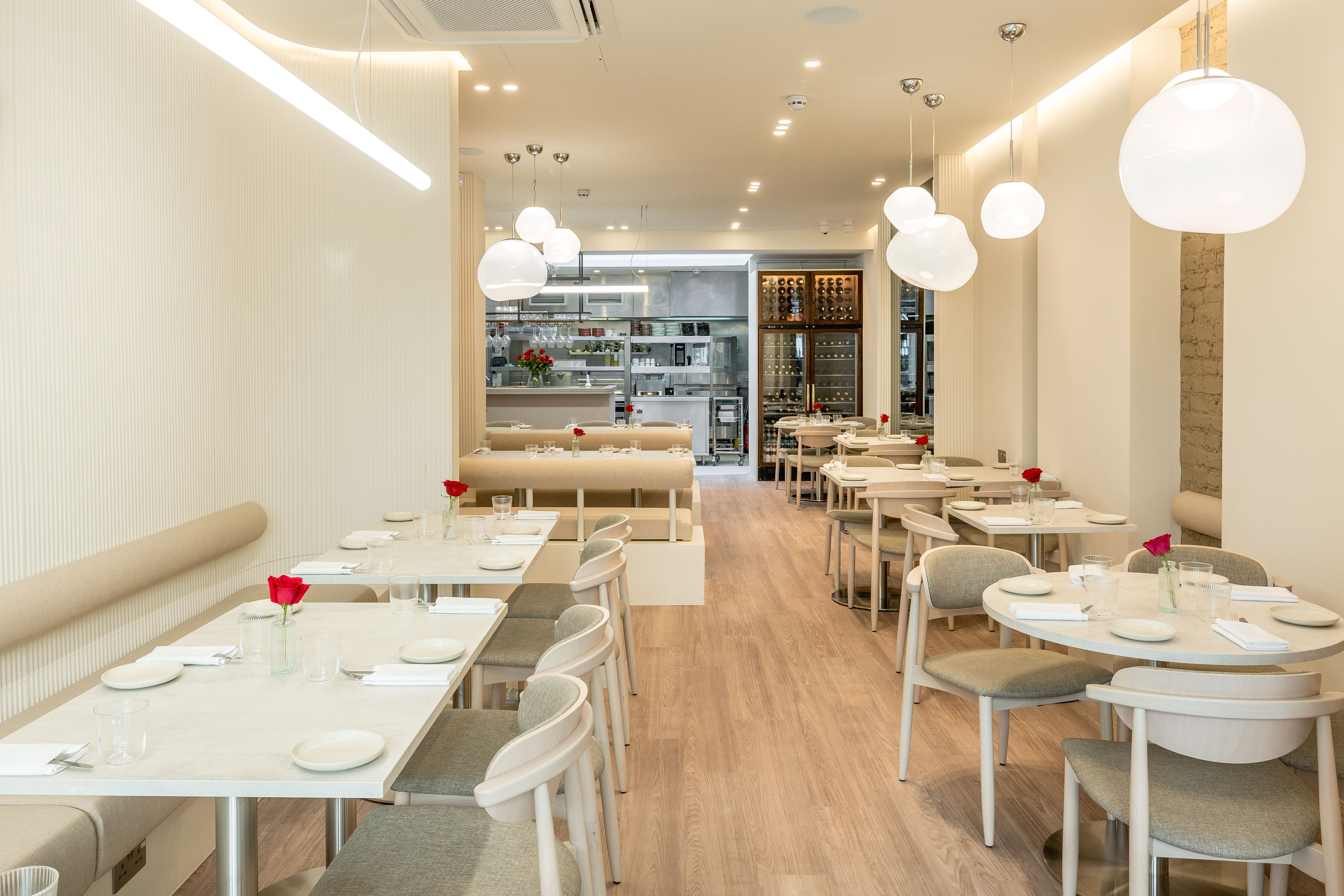 Minimalist Botwa restaurant featuring banquette seating for corporate breakfasts and networking.
