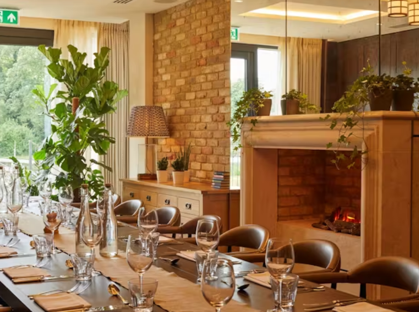 Private dining at Wagtail, Streatley: elegant boardroom with cozy fireplace for exclusive events.