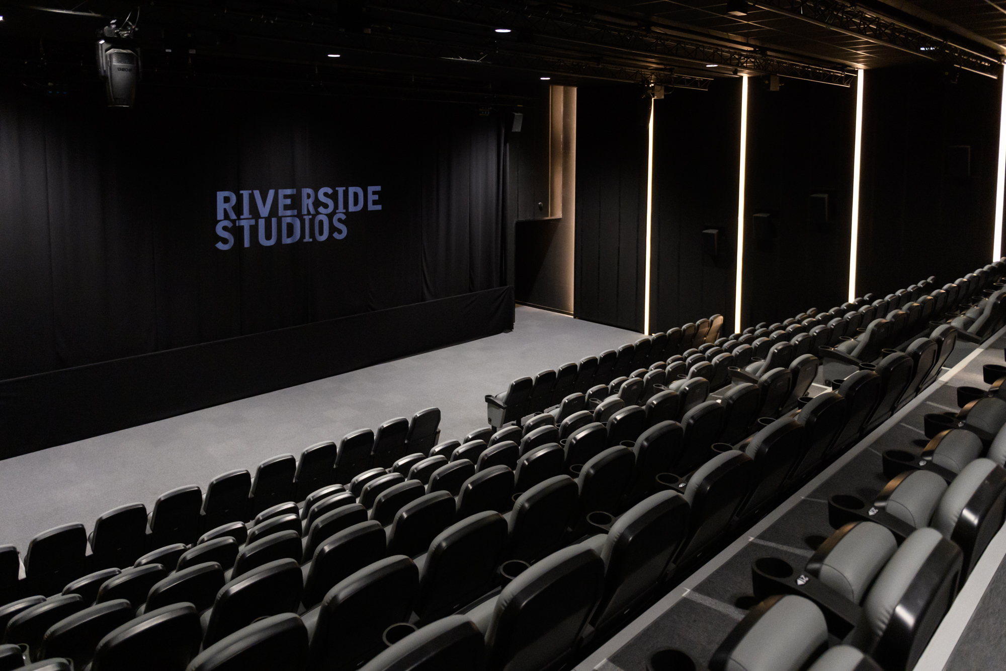 Modern auditorium with tiered seating at Riverside Studios for events and performances.