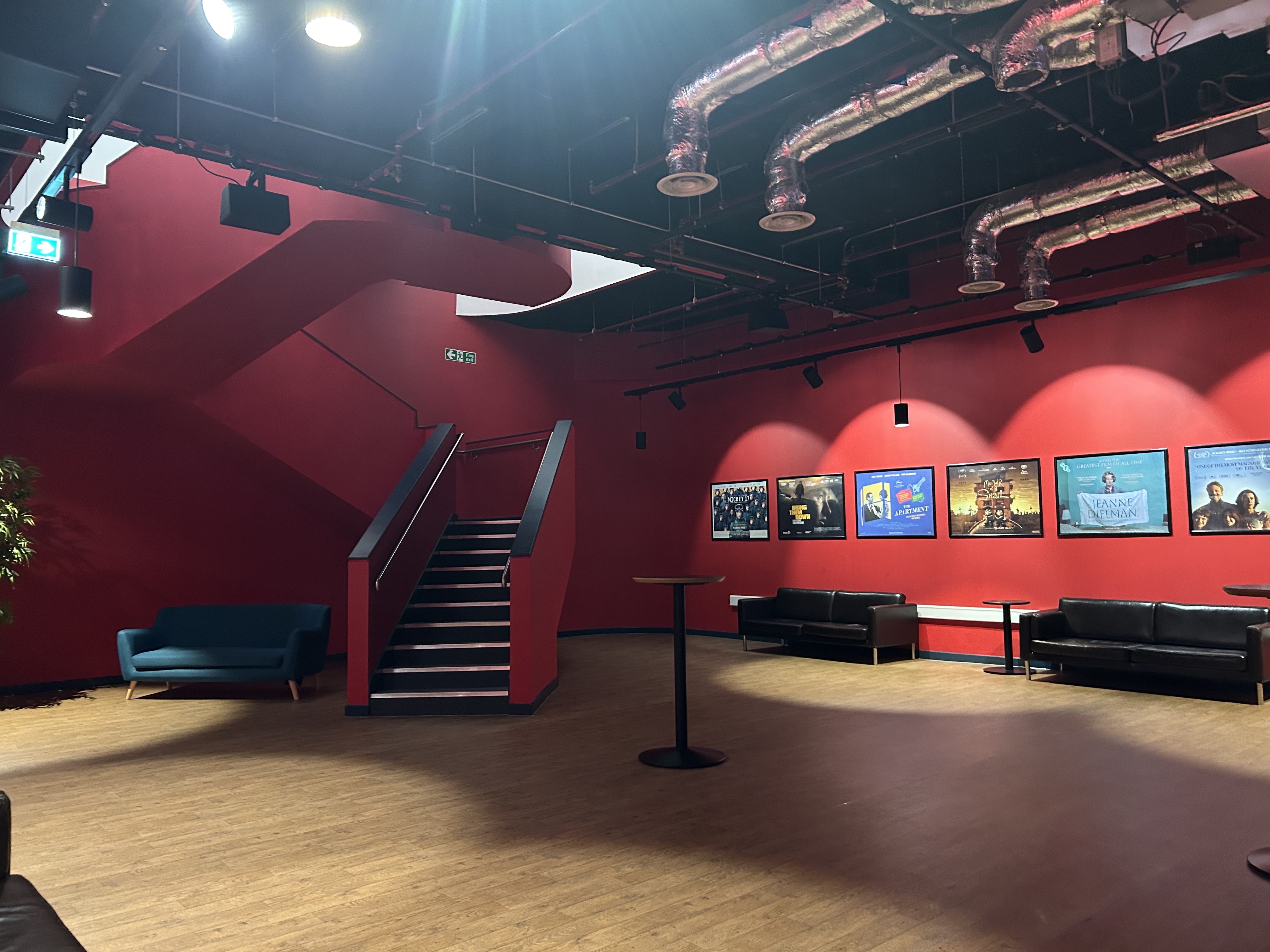 Modern Riverside Studios event space with red decor, ideal for meetings and gatherings.