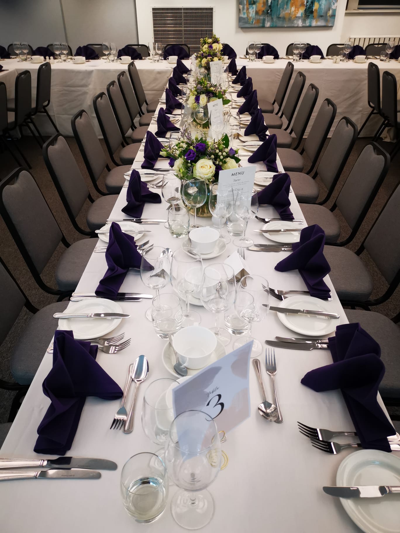 Elegant dining table with floral centerpiece at Royal College of Anaesthetists event.