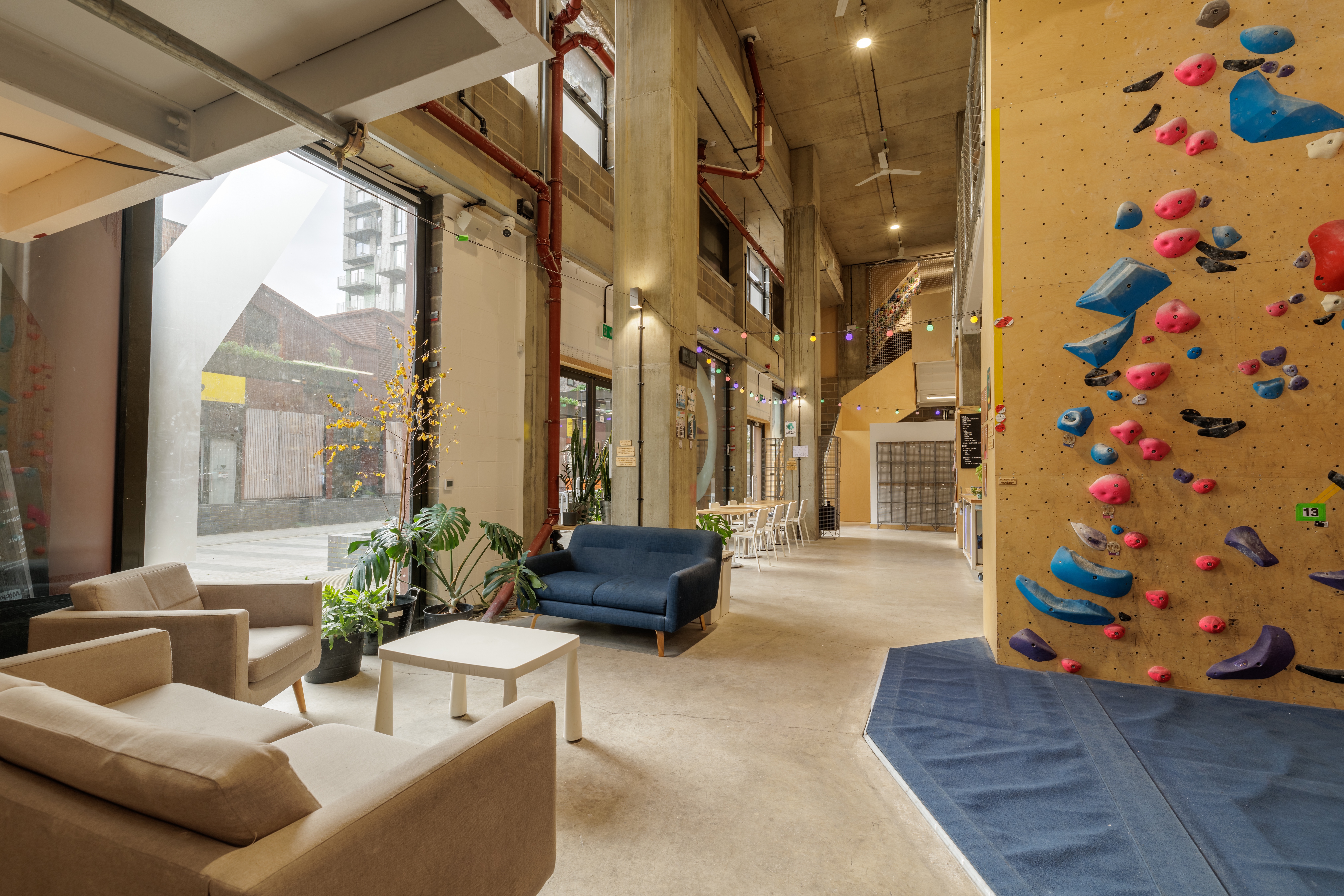 Vibrant event space with climbing wall, perfect for corporate retreats and workshops.