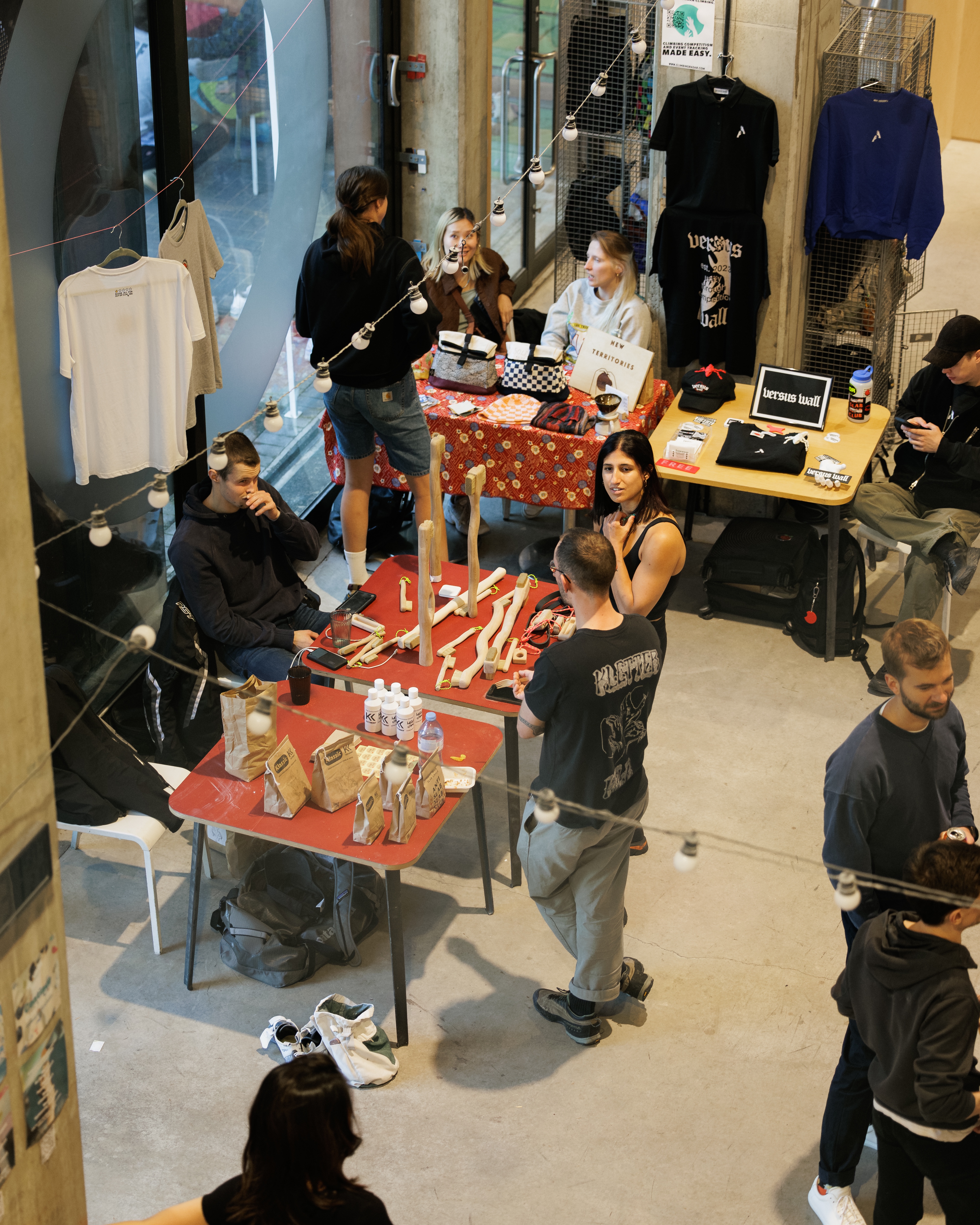 Vibrant marketplace at Rise Climbing event with booths, vendors, and string lights.