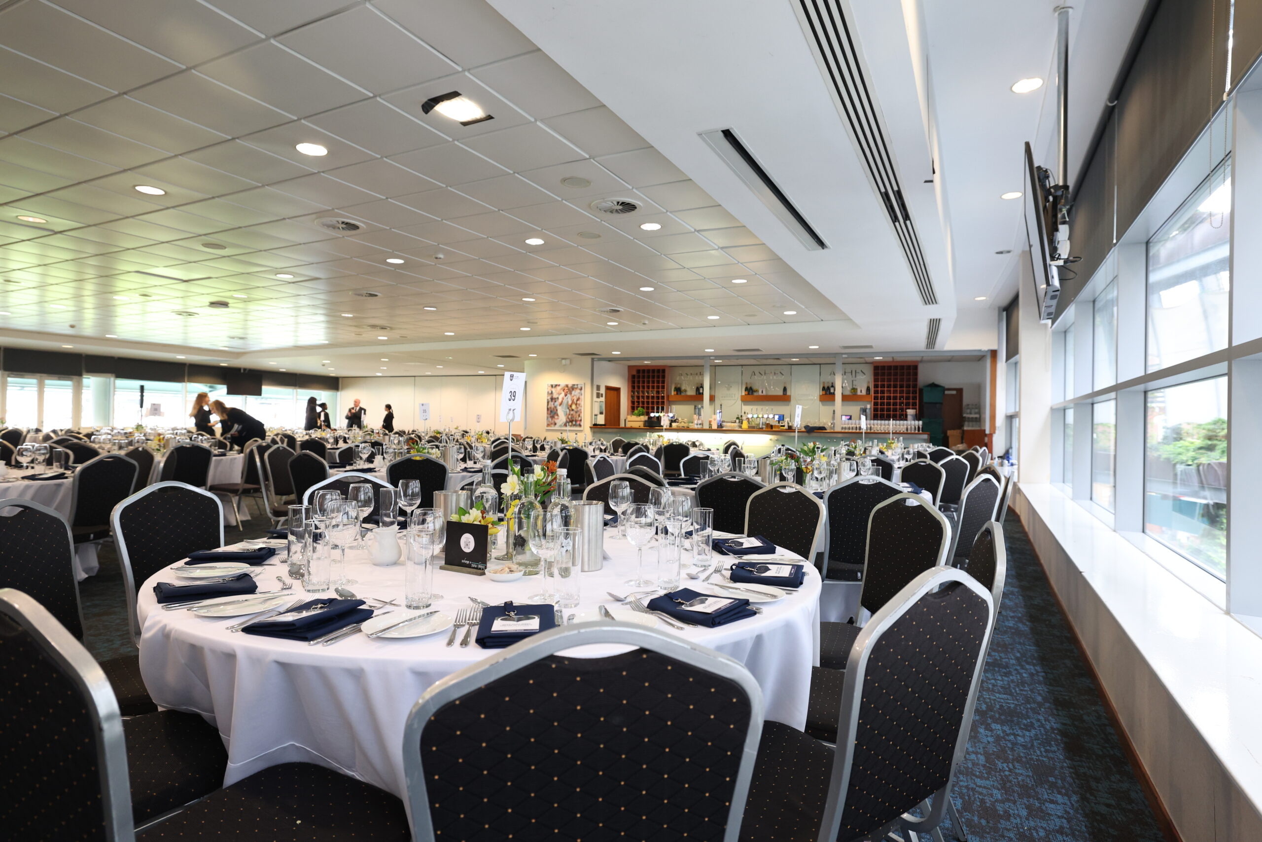 Elegant Ashes Suite at Kia Oval, set for formal dinner events with round tables.