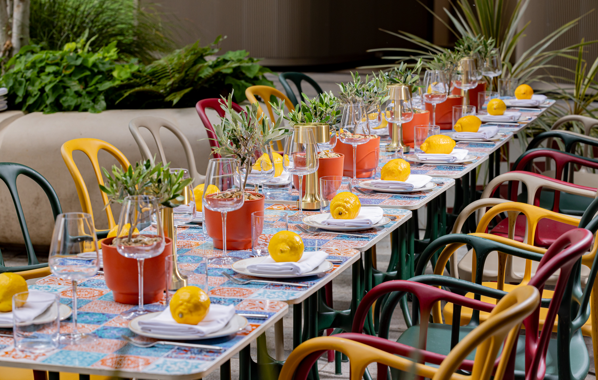 Outdoor event setup at Tozi Terrace, art'otel London with vibrant chairs and fresh lemons.