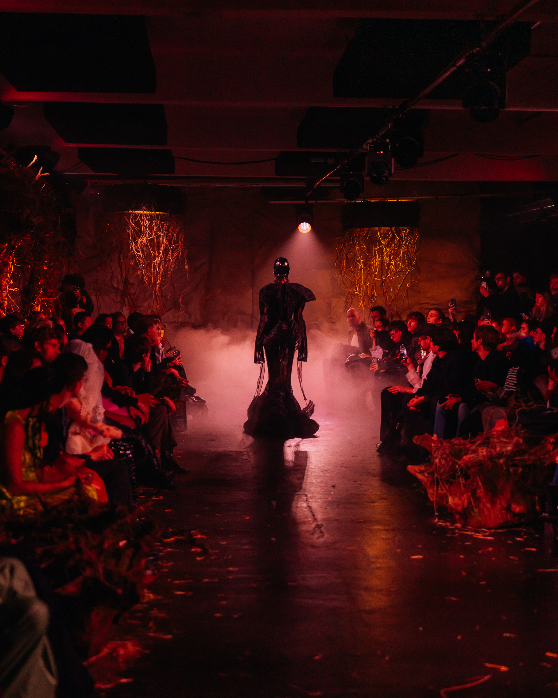 High-energy fashion runway event with striking model and dramatic lighting in Shoreditch.