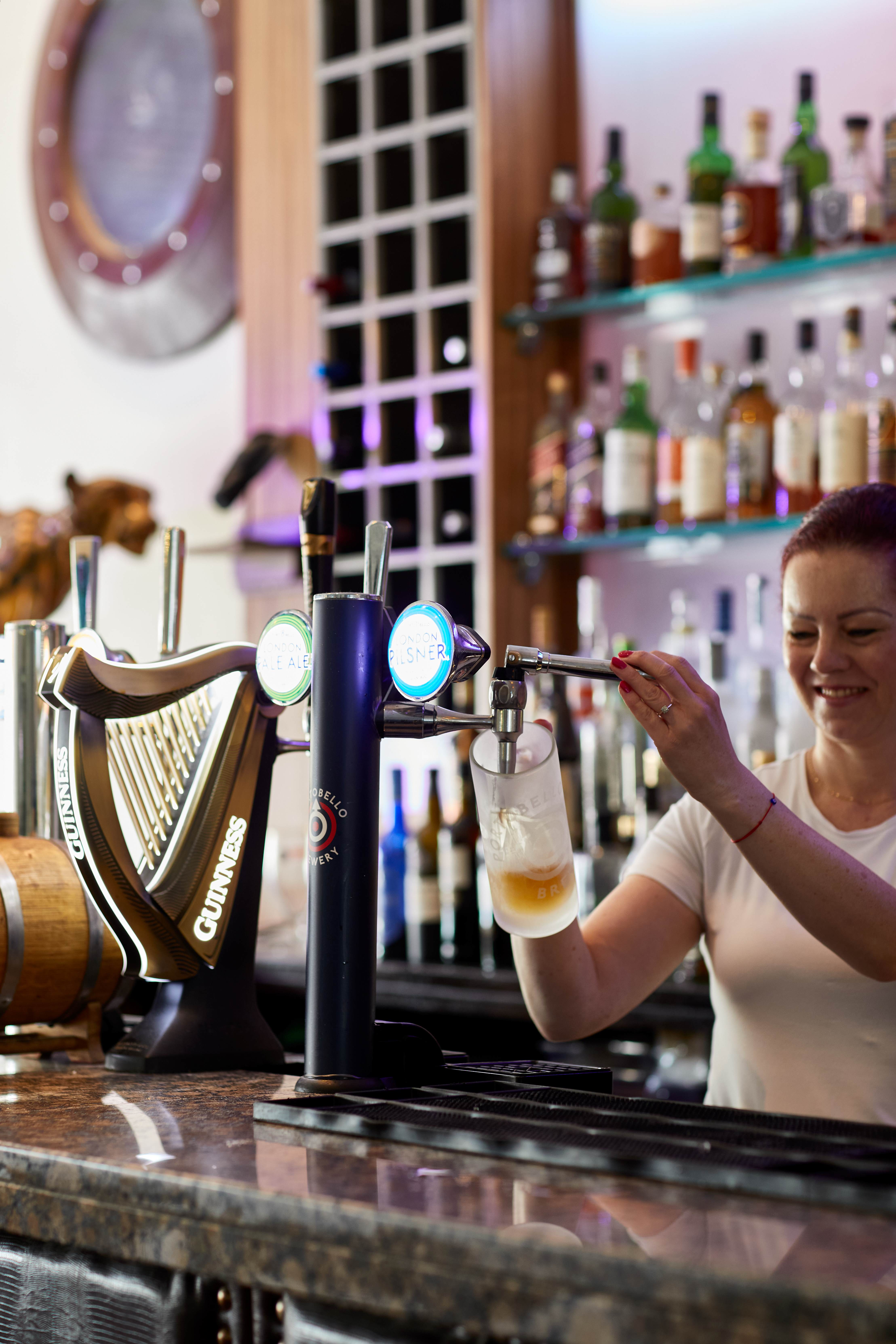 Bartender pouring Guinness at bbar, showcasing skilled service for memorable events.