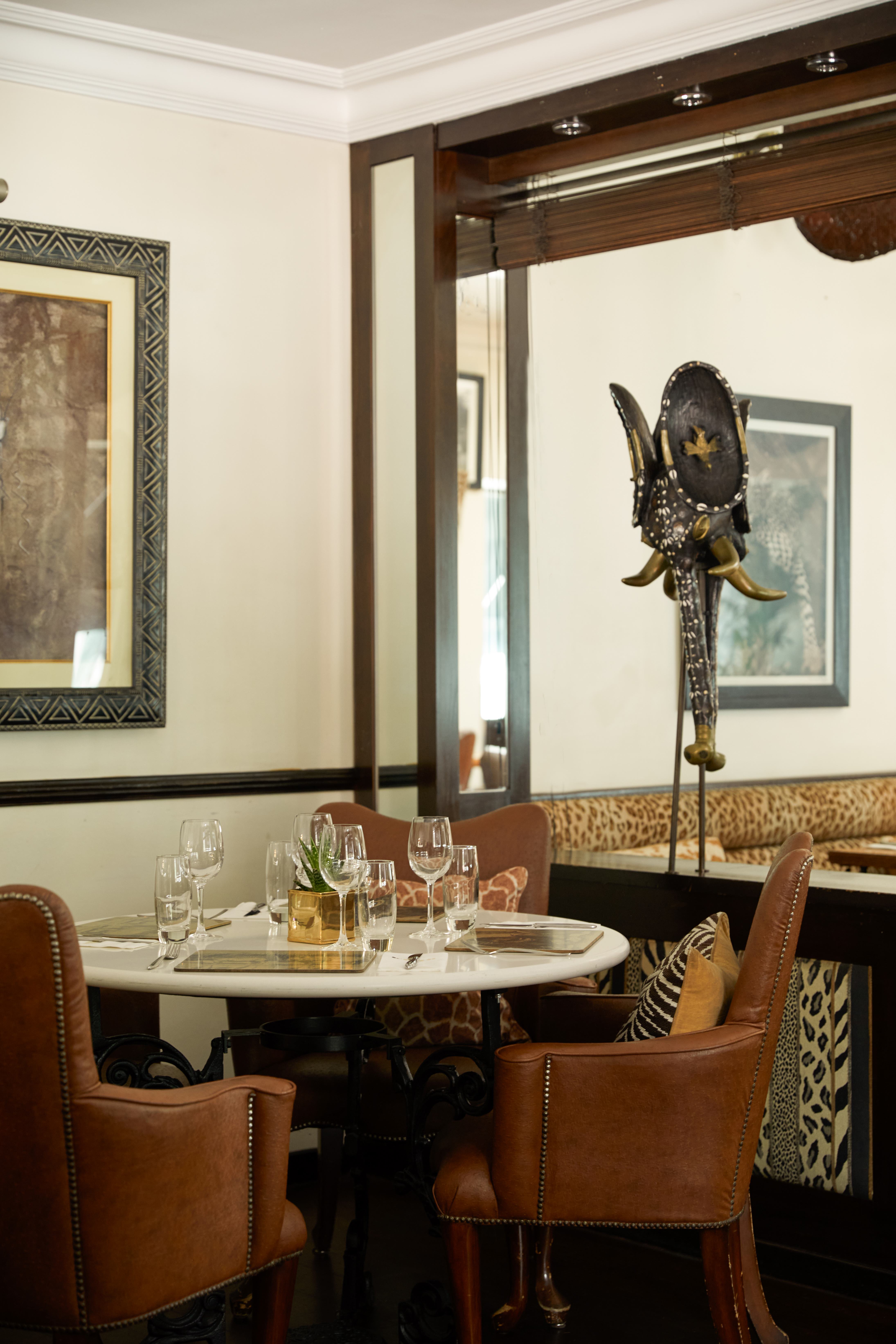 Elegant dining setup at Upper Bar, featuring unique elephant sculpture for corporate dinners.