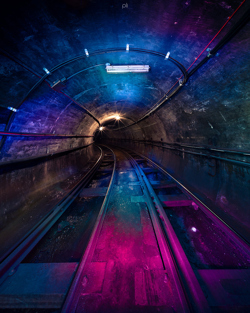 Illuminated tunnel with blue and purple lights, perfect for unique events and gatherings.