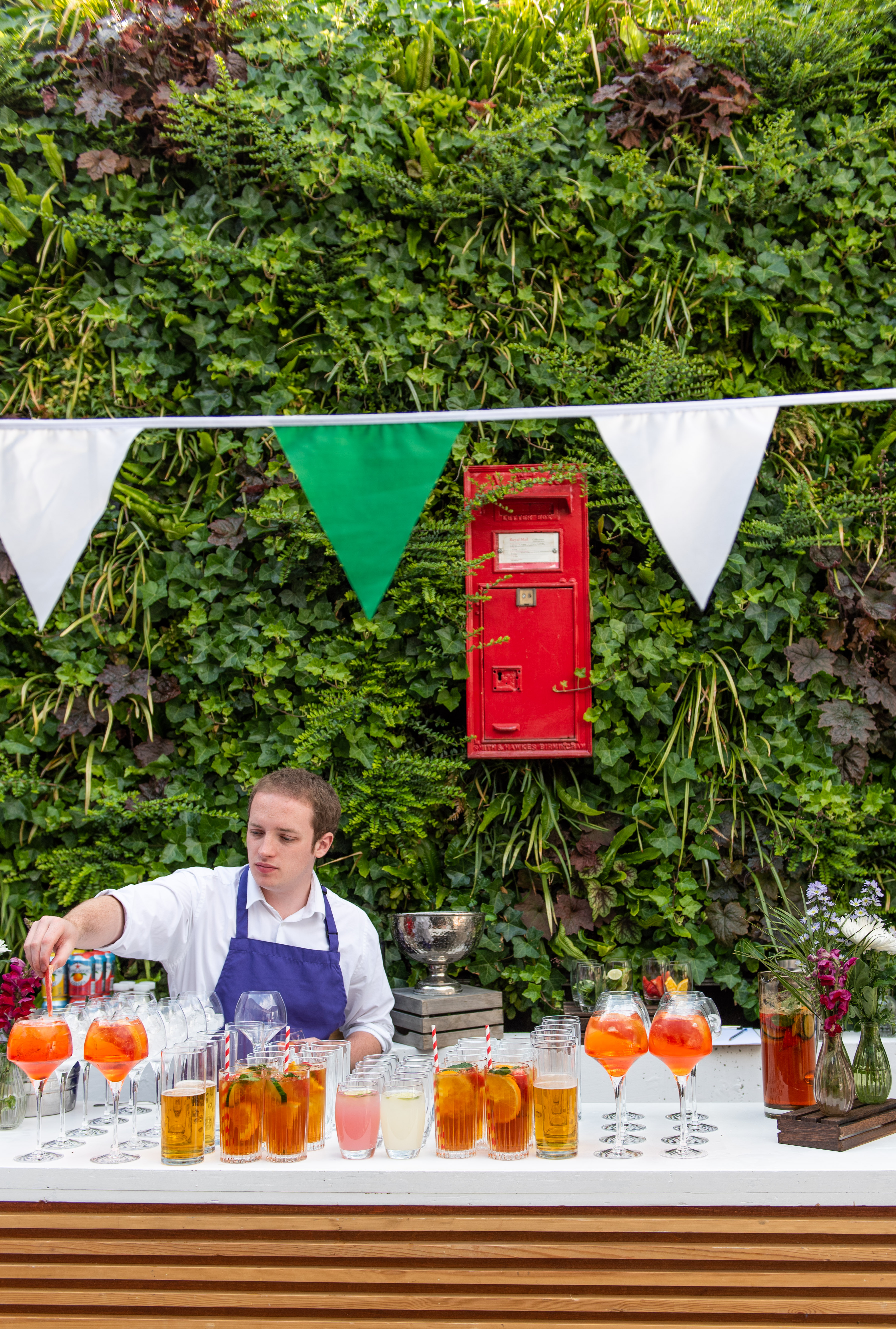 Summer party beverage station with cocktails in The Postal Museum courtyard.