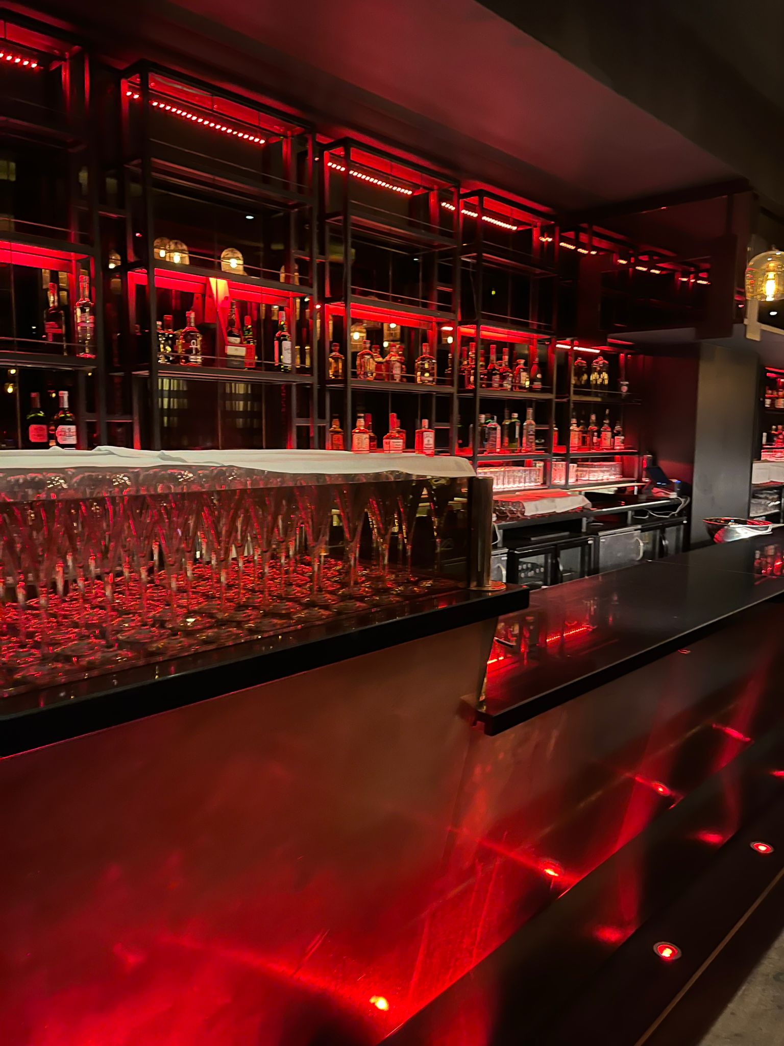 Luxury bar, red lighting, cocktail reception, VIP event