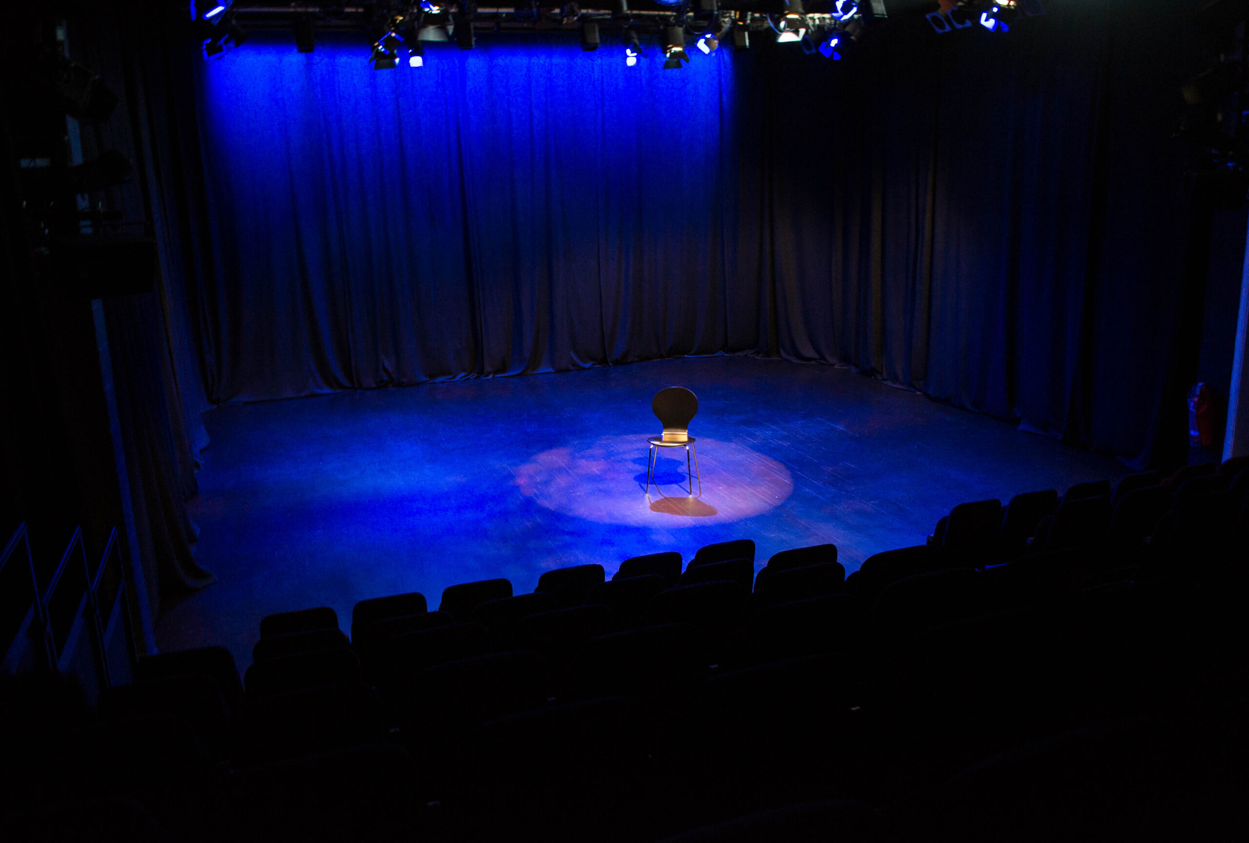 Brentwood Theatre auditorium, minimalist stage for keynote presentations and fireside chats.