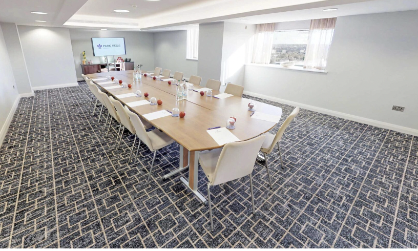 Meeting room at Park Regis Birmingham with polished table, ideal for professional gatherings.