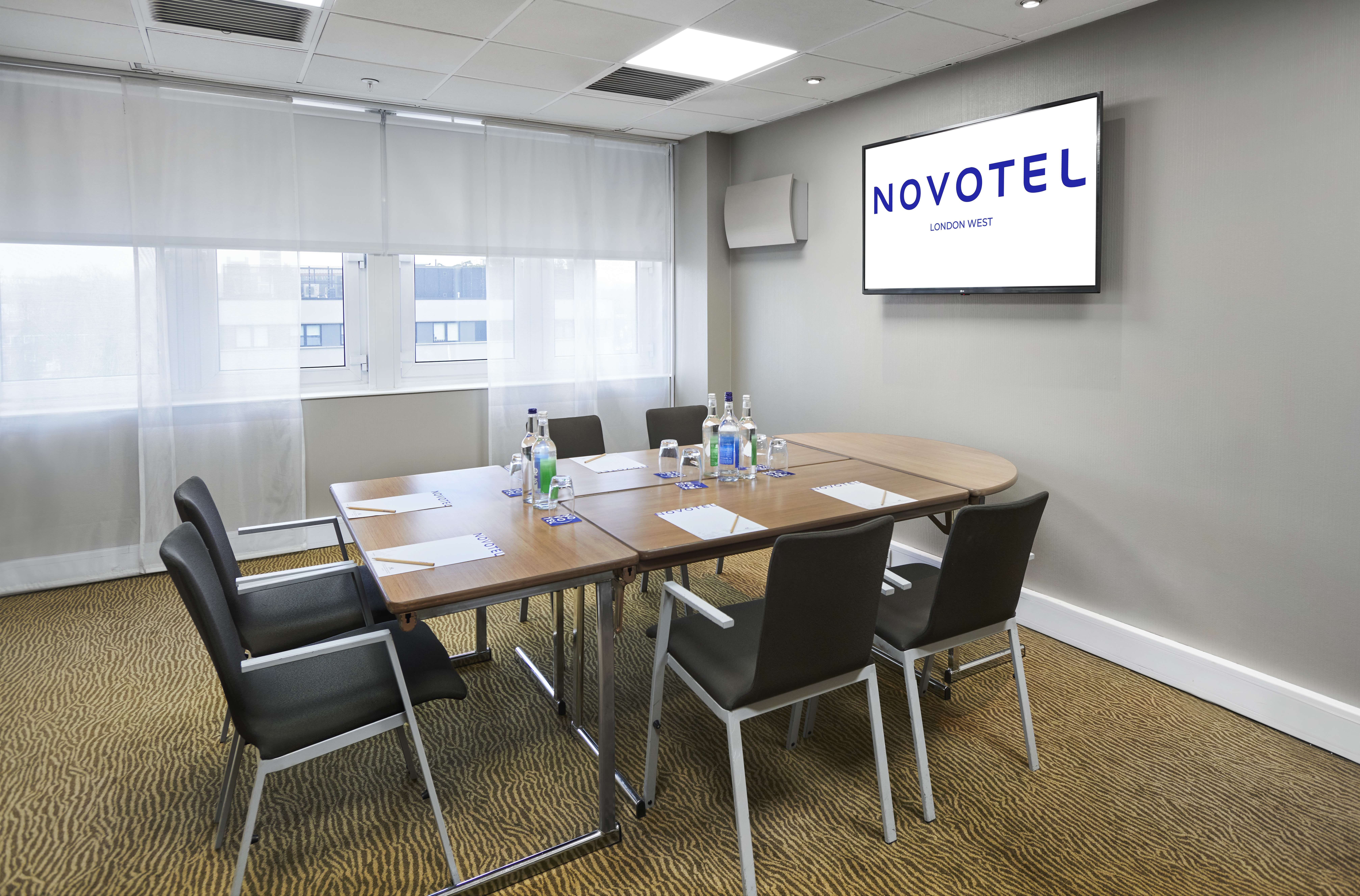 Medoc meeting room at Novotel London West with oval table, ideal for conferences.