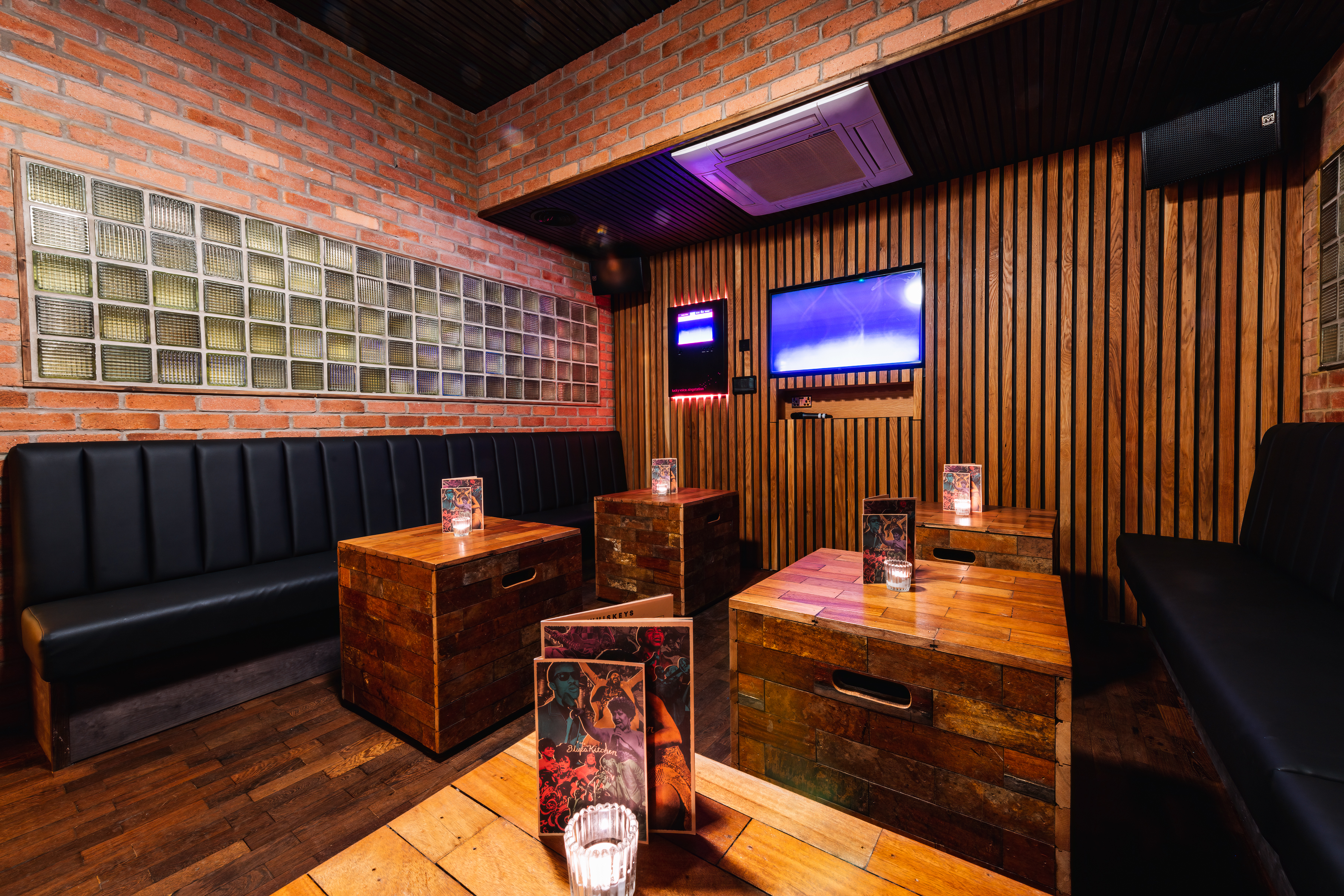 Karaoke room at The Blues Kitchen Manchester with cozy seating for private events.