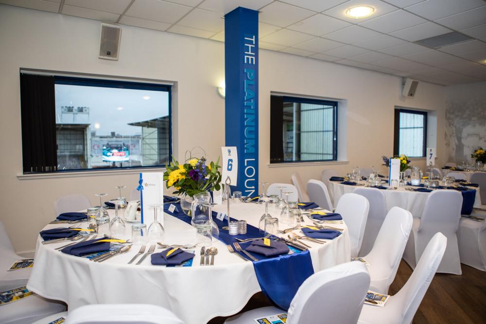 Hall of Fame Lounge banquet setup with blue table runners for corporate events or social meetings.