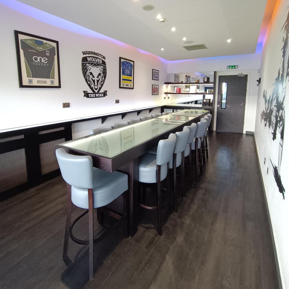 Boardroom setup at Halliwell Jones Stadium for corporate meetings and strategy events.