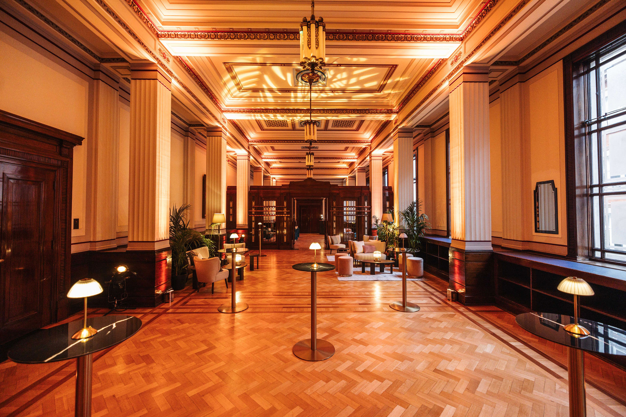 Elegant Long Room venue with polished wooden floors for meetings and social gatherings.