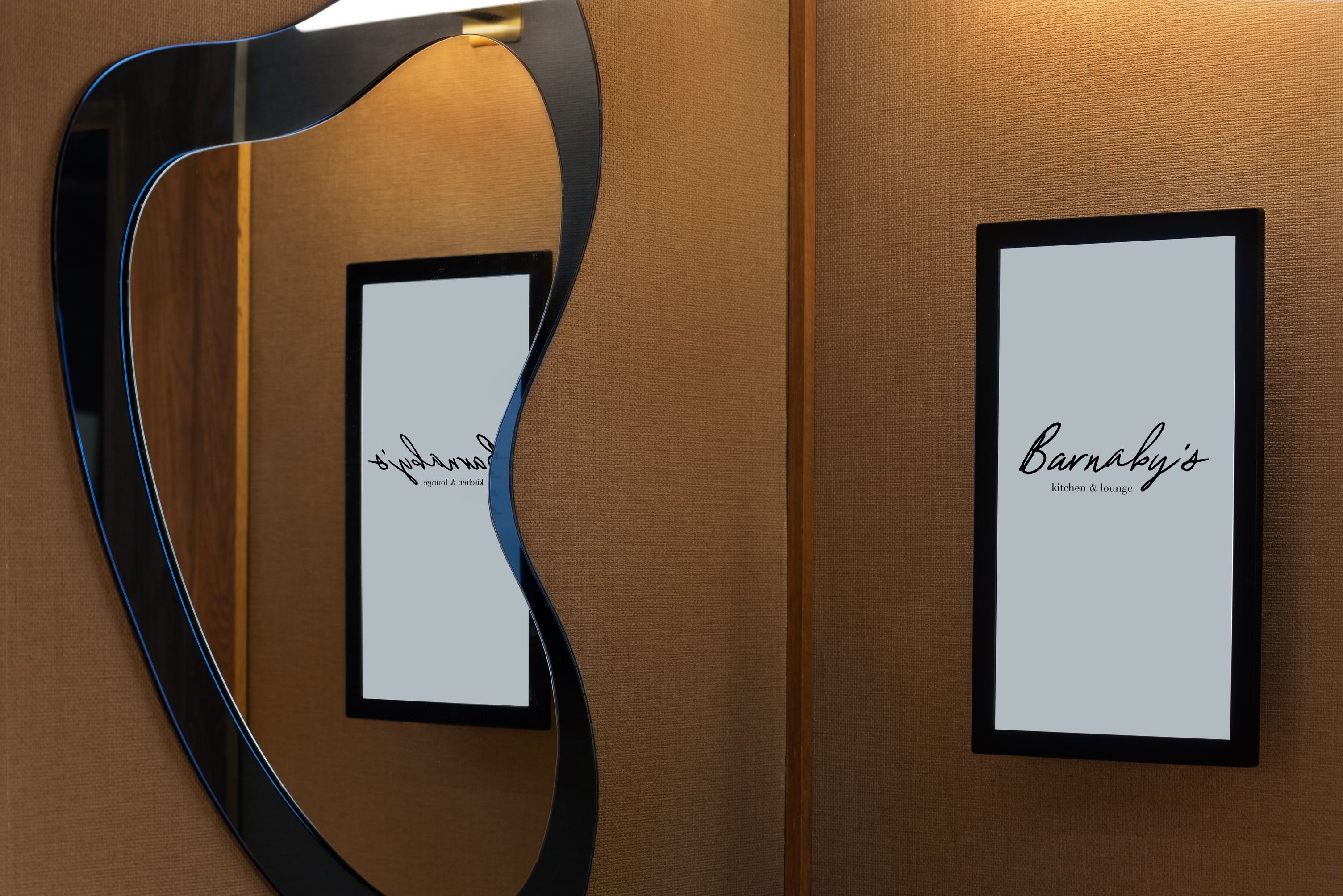 Stylish restroom at Barnaby's Lounge Bar, modern mirror, ideal for upscale events.