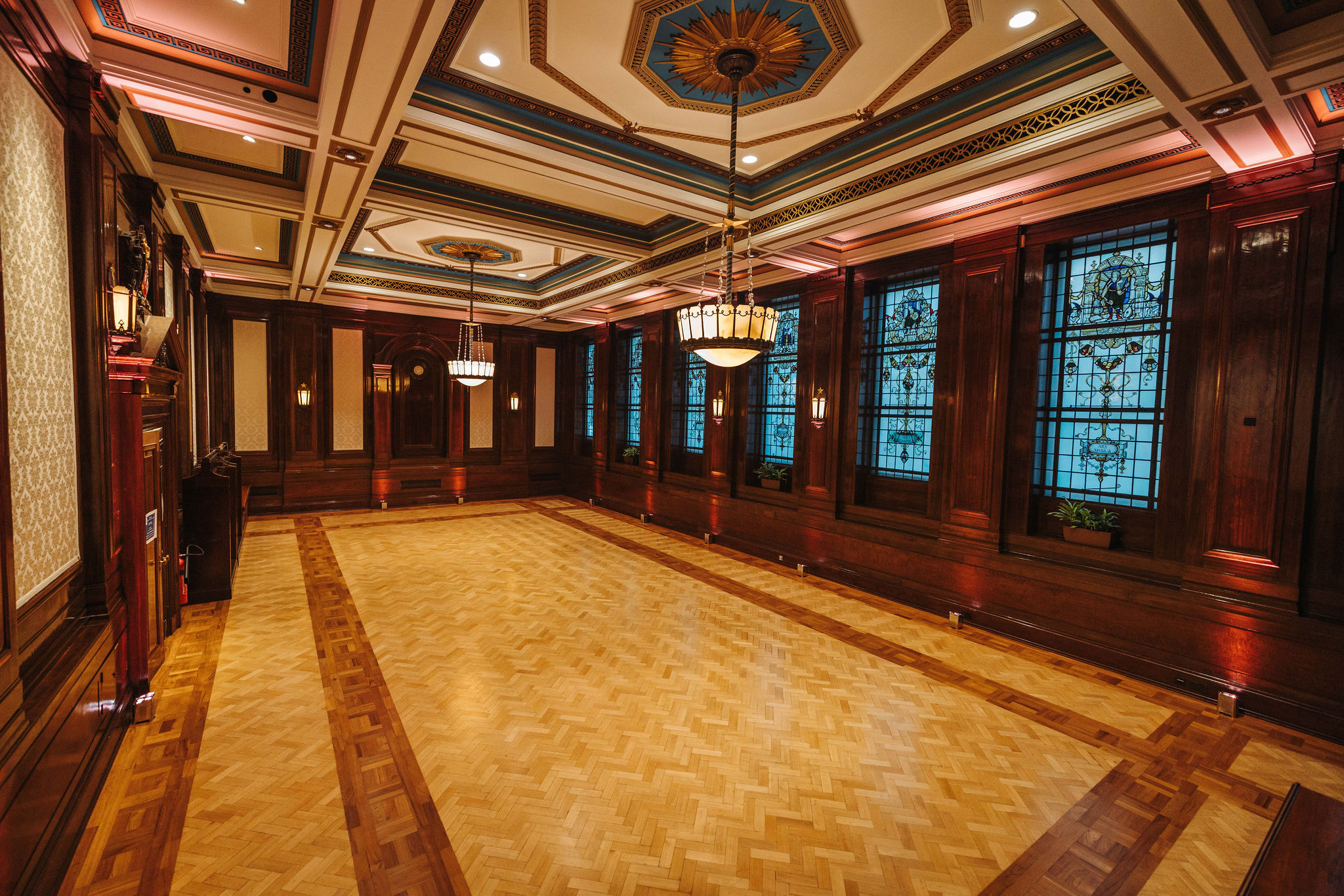 Elegant Old Boardroom event space with stained glass windows for upscale gatherings.