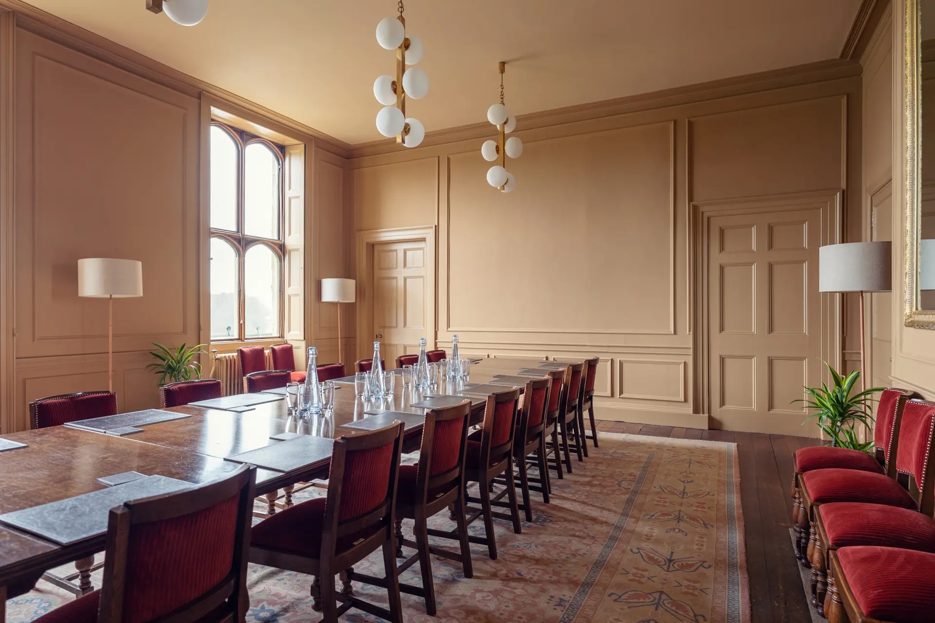 Boardroom at Ashridge House with elegant wooden table, ideal for corporate meetings.