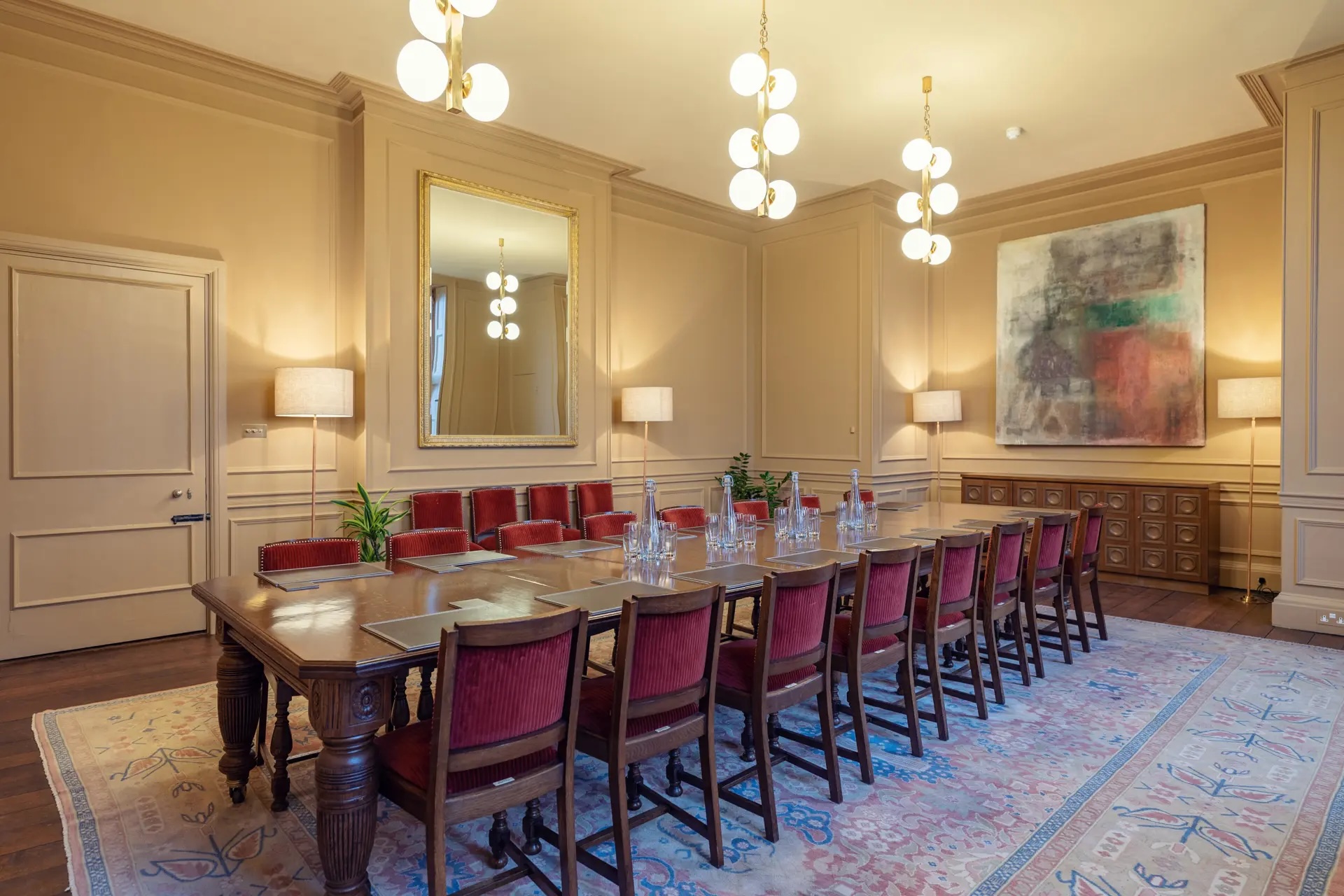 Boardroom in Ashridge House with elegant wooden table, ideal for meetings and presentations.