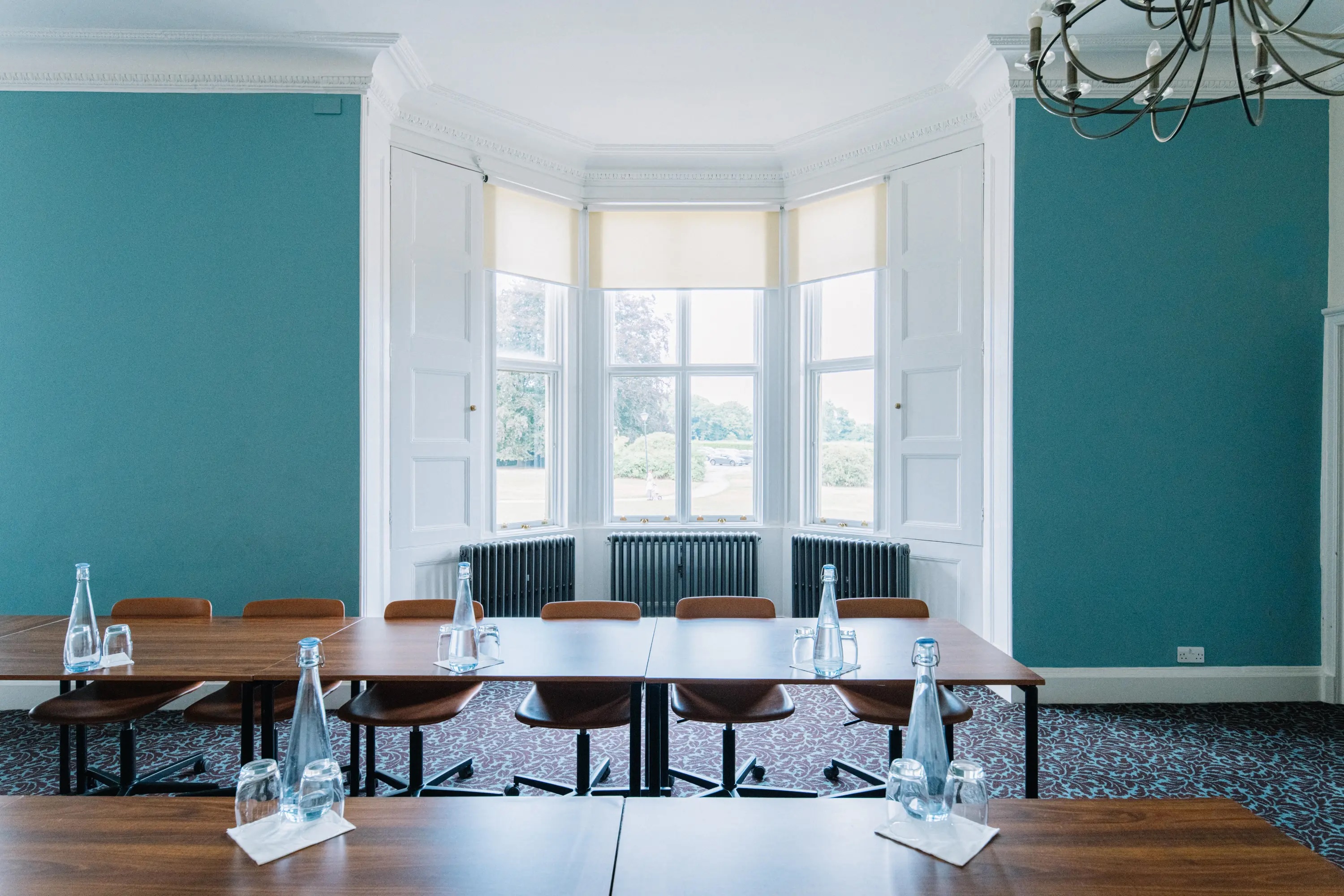Elegant meeting room at Ashridge House, featuring a long wooden table for corporate events.