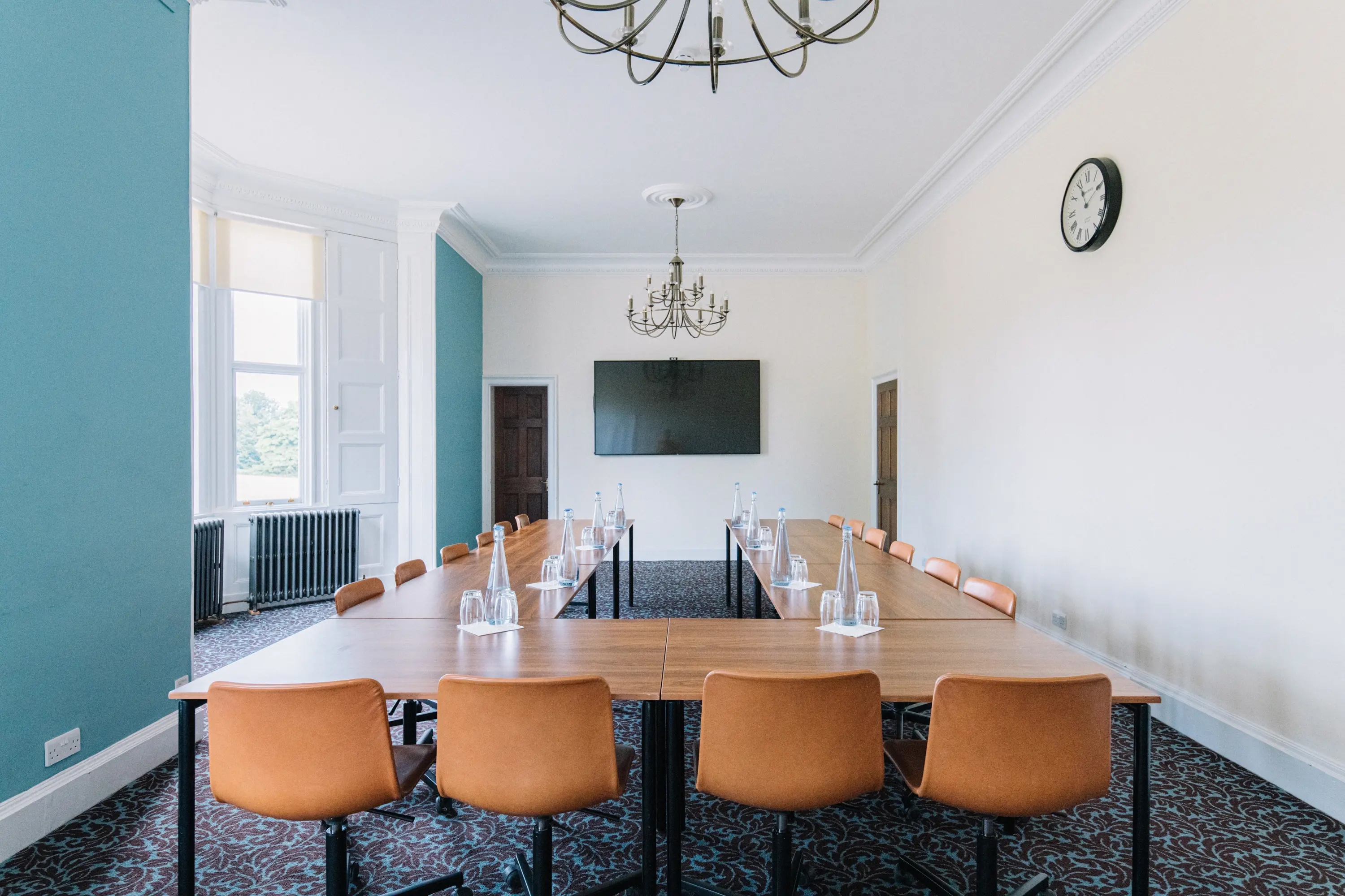 Meeting room at Ashridge House with elegant chandelier, ideal for corporate events.